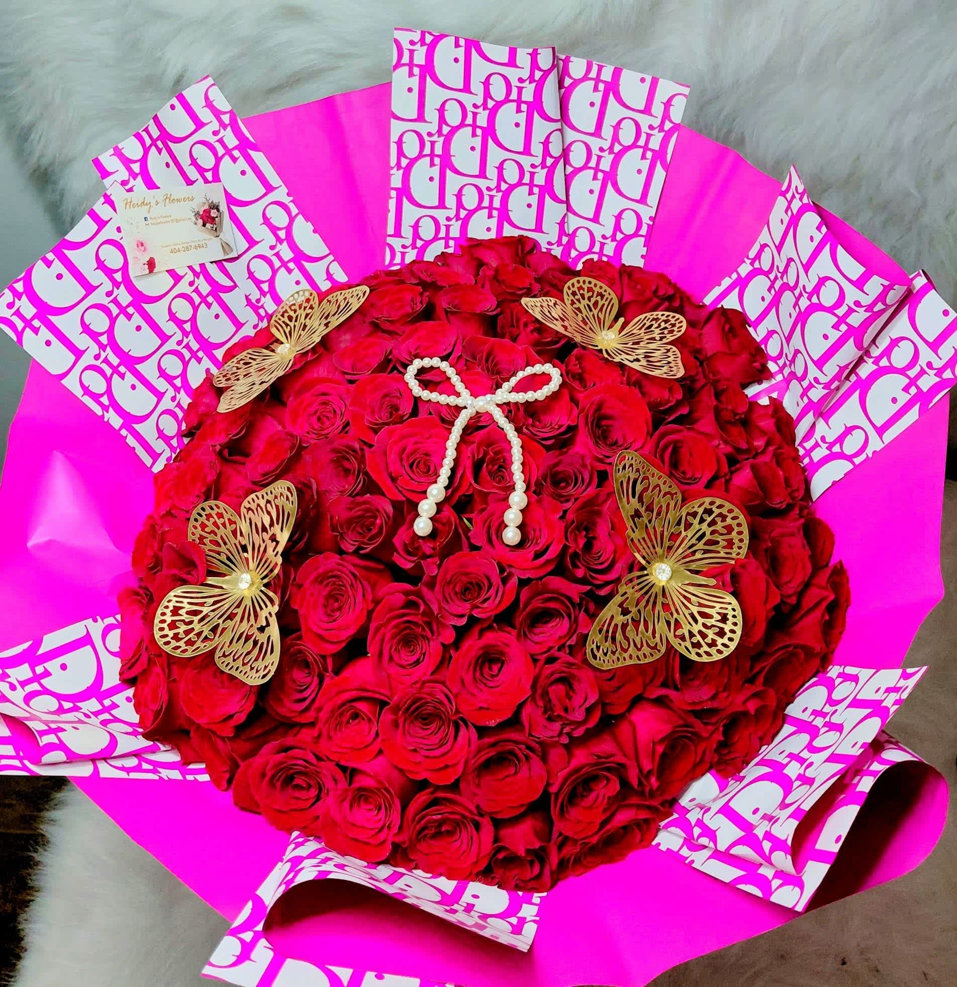 100  red rouses  - 100 beautiful red rouses. Wrapped  with butterflies  snd dior paper. 
