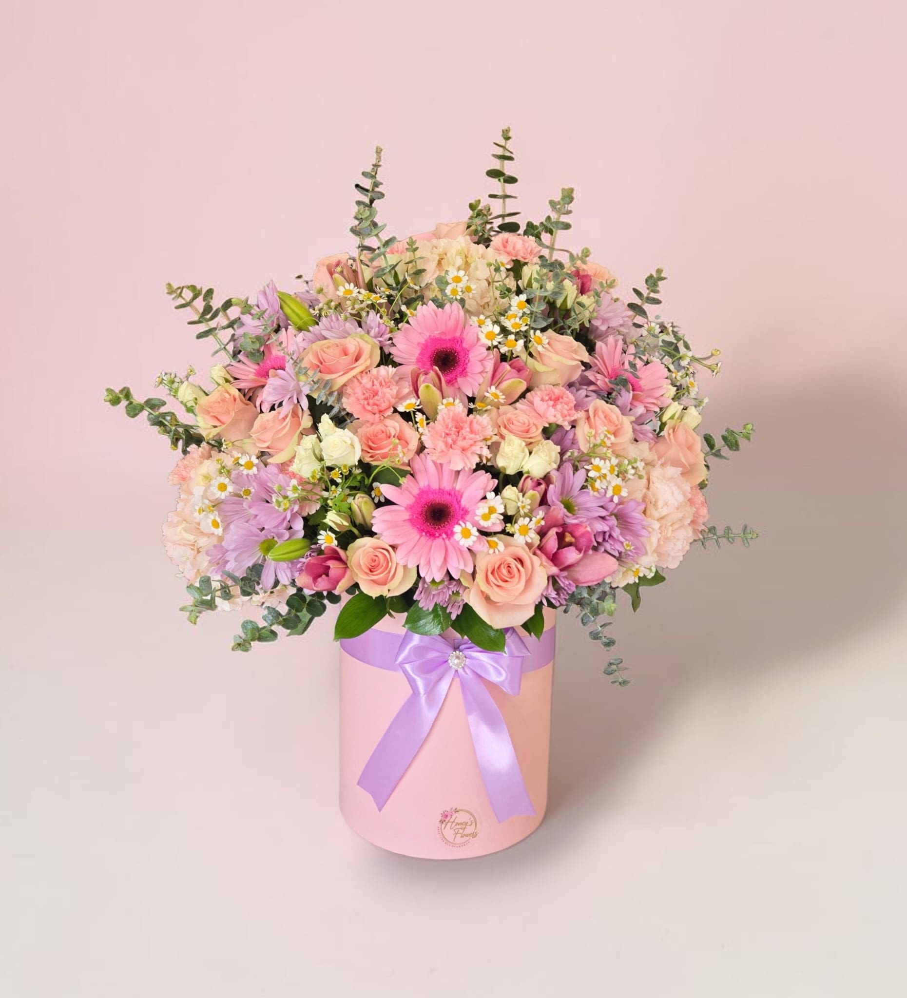 Siempre Bella - Full pink-and-lavender hatbox bouquet with roses, gerbera, carnations, chrysanthemums, eucalyptus accents