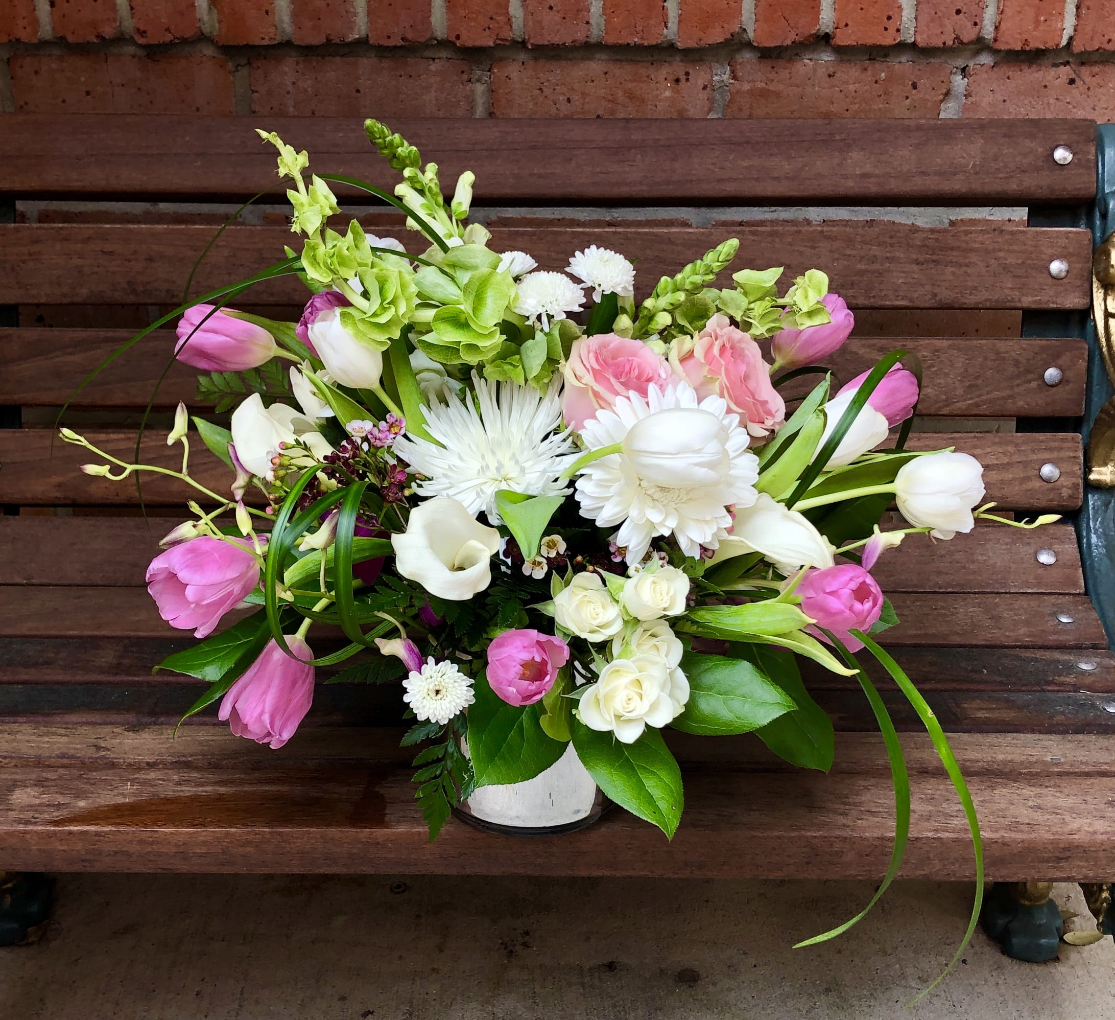 Pink and white mixed flower arrangement in a white vase