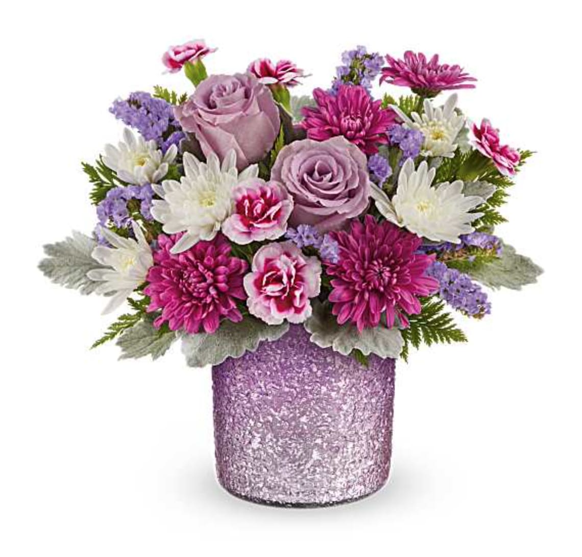 Radiant Reverie - Make Mom's day shine with our Radiant Reverie cylinder vase, featuring a textured and shimmering gradient finish in soft purple-an elegant keepsake perfect for displaying a dreamy Mother's Day bouquet. The Radiant Reverie Bouquet features light lavender roses, variegated purple miniature carnations, purple cushion spray chrysanthemums, white cushion spray chrysanthemums, lavender sinuata statice, dusty miller, and leatherleaf fern. Arranged in a textured, shimmering purple gradient vase, it's a perfect Mother's Day gift. Orientation: All-Around  SUBSTITUTION POLICY – Always deliver the freshest flowers! Please note the bouquet pictured reflects our original design.  If the exact flowers or container in this arrangement are not available, our local florists will create a beautiful bouquet with the freshest available flowers.