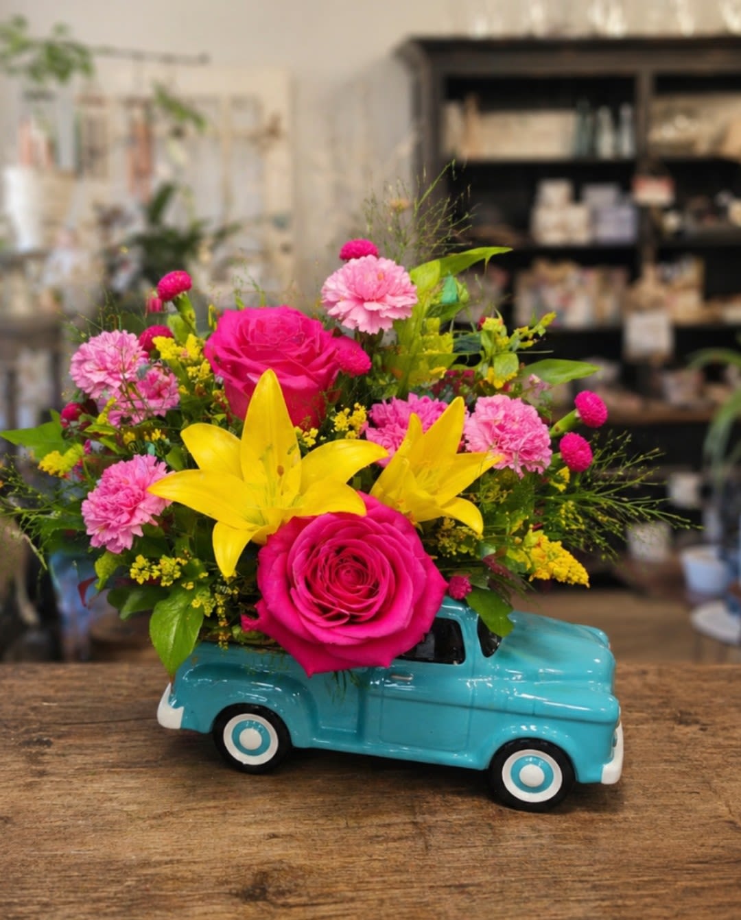 Custom Classic Chevy Pickup - A unique and charming floral arrangement designed in a vintage Chevy truck ceramic container. The image is an example of a completed design; each one is custom and filled with the freshest available flowers.