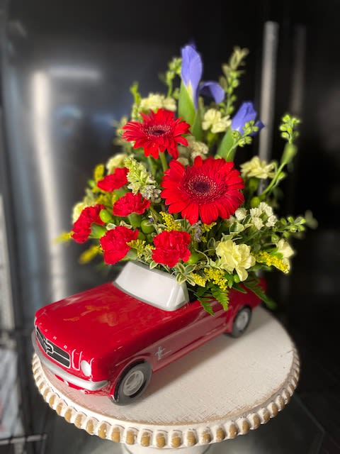 Dad's Dream Wheels - This Father's Day, get Dad's motor running with this collectible gift! In the perfect shade of poppy red, this classic '65 Ford Mustang presents an array of vibrant flowers. What a beautiful, fun-filled display for dad's desk or bedroom!