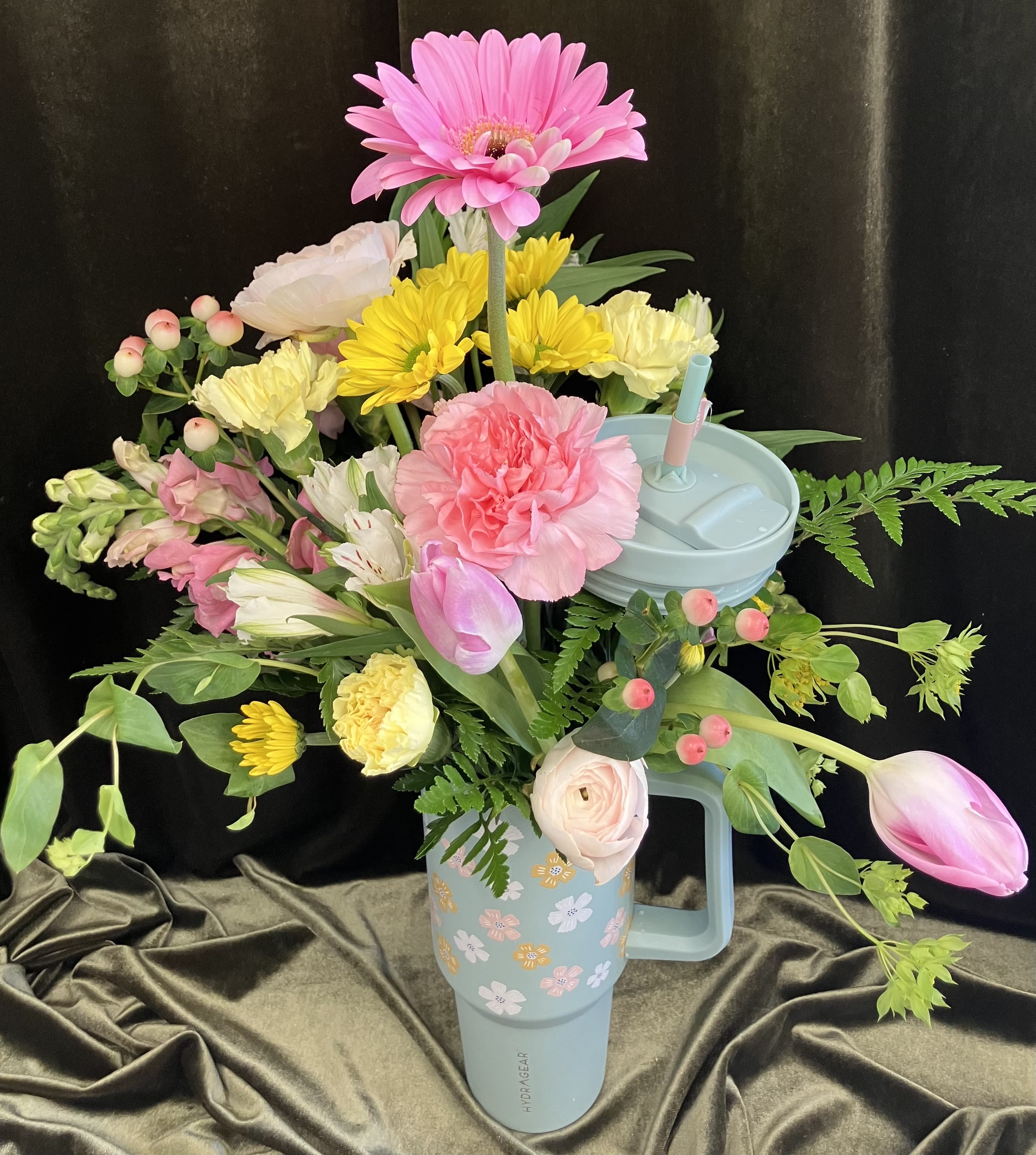 Large Tumbler Arrangement - Pretty tumbler with a lovely assortment of fresh flowers, pink ranunculus, tulips, snapdragons, yellow daisy, and a pretty pink gerbera daisy! Perfect gift for Mother’s Day or a birthday!