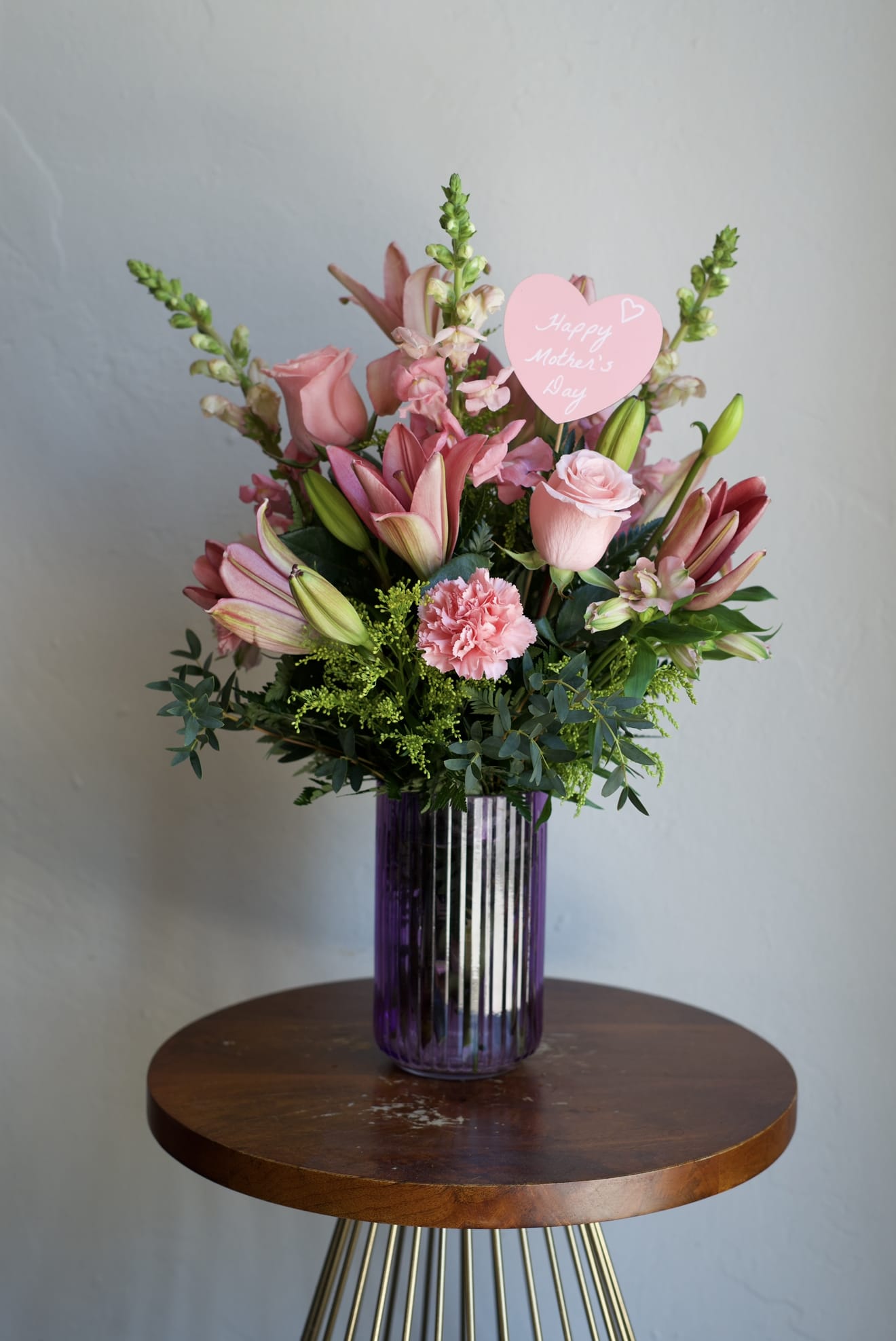 Pink Blooms - Small Arrangement - Mix of season flowers with lush florals which may include roses, gerbera daisies, carnations, lilies and snapdragons arranged in a vase. Pink color palette