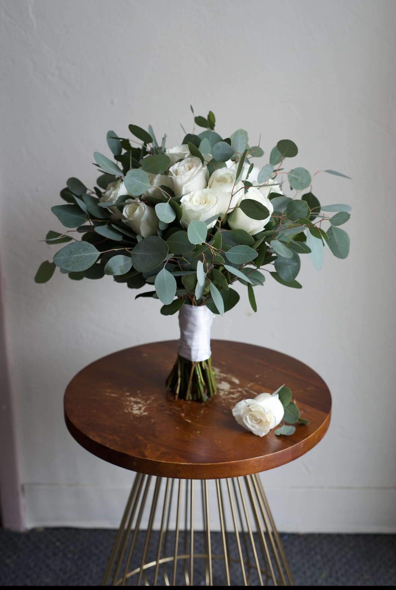 Elopement Blooms - A thoughtfully curated elopement set featuring a bridal bouquet and matching boutonniere, designed for intimate celebrations and effortless elegance. The bouquet is styled with fresh, roses and silver dollar eucalyptus in a natural, romantic arrangement, while the boutonniere is crafted to complement the design with a refined, cohesive touch. Perfectly suited for courthouse ceremonies, destination elopements, or quiet vows, this set brings a sense of beauty and meaning to your most personal “I do.”