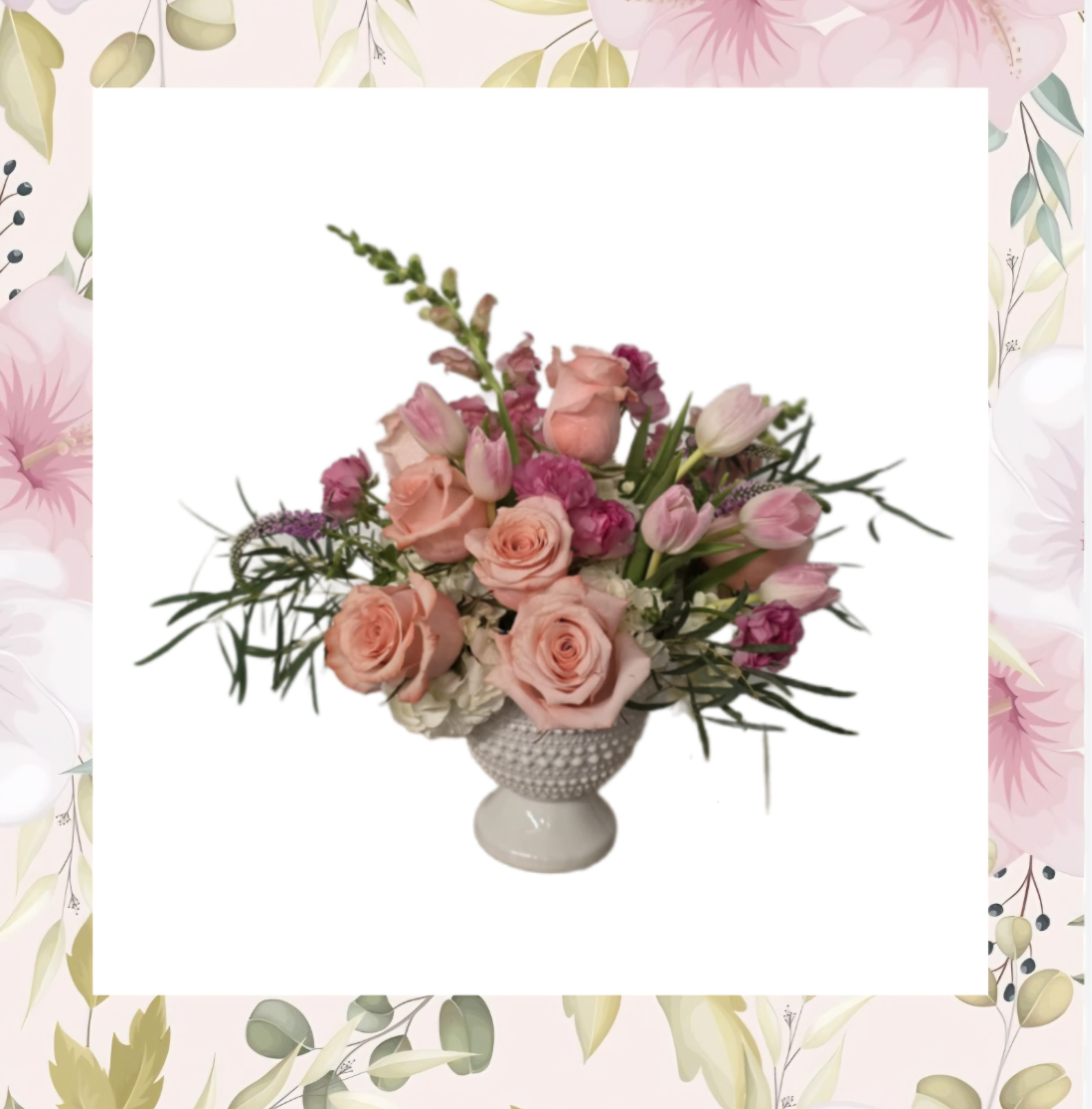 Pink roses and tulips arranged in a white pedestal vase