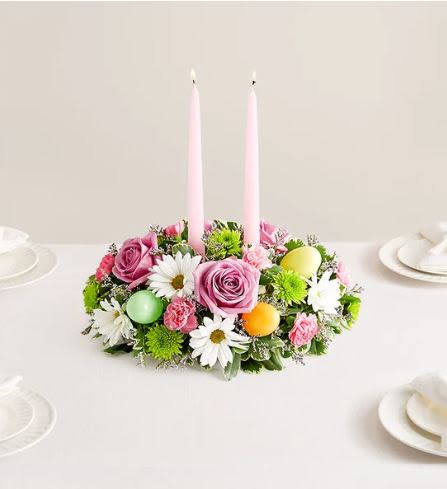 Easter Flower Centerpiece -  Pet Friendly? No This arrangement contains Daisy Poms and Button Poms (Chrysanthemums), which are toxic to cats and dogs if ingested.    Human Allergy Note This centerpiece contains pollen-heavy Daisy Poms and Asters which may trigger sensitivities. We recommend keeping the arrangement in a well-ventilated area and away from sleeping quarters or direct airflow from vents.   Care &amp; Longevity To keep your centerpiece fresh, check the water level daily by feeling the floral foam base. Add water gently to the center of the foam until saturated, being careful not to get the candles or decorative eggs wet. Keep the flowers away from direct sunlight, heat sources, or drafts, and remove any fading blooms to keep the rest of the arrangement healthy.    Best Occasions &amp; Situations  Easter and Passover — perfect spring table centerpiece  I’m sorry — gentle pastels convey care  Thinking of you — sends comfort and warmth  Fourth of July — soft alternative for spring hosting  Housewarming — fresh gift for new spaces  Birthday — sweet for spring birthdays  Why Customers Love It Low-profile design allows for unobstructed views across the dinner table. Dual-purpose decor combines fresh blooms with functional holiday candles. Lush color balance of pastels and bright greens creates a vibrant spring feel. Gift-ready presentation with festive Easter egg accents included.