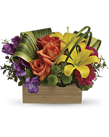 Orange roses and yellow lilies in a wooden box