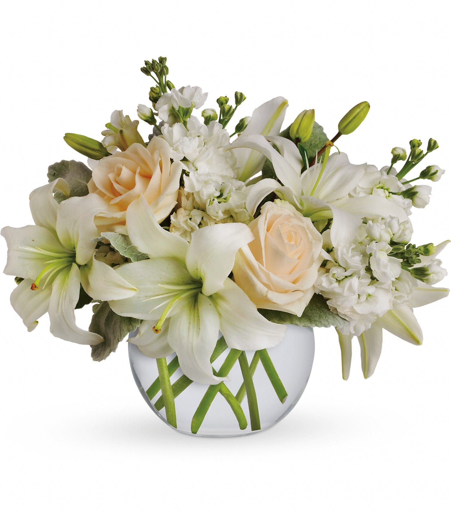 White lilies and cream roses arranged in a round glass vase