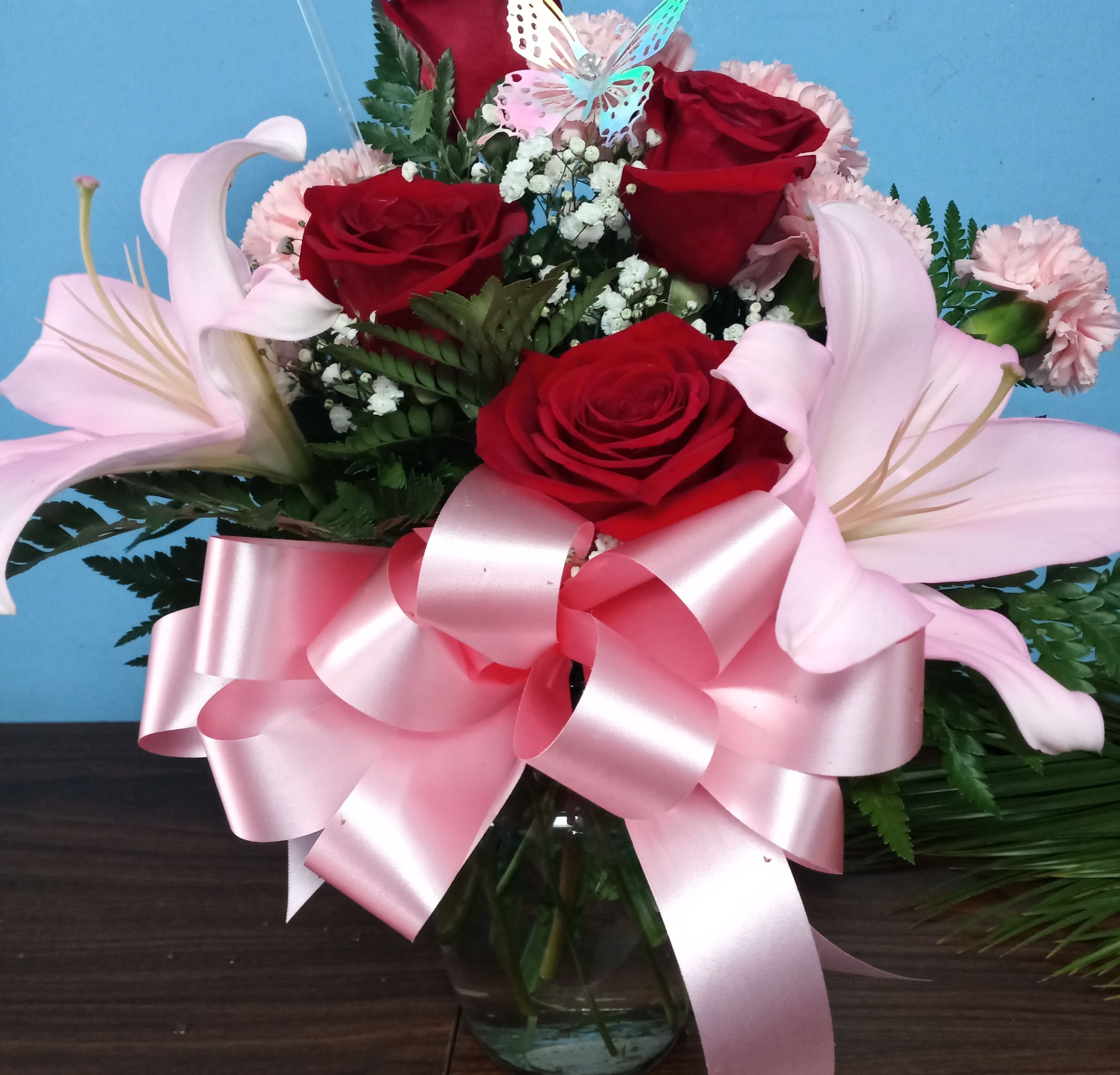Heart's Emotions - Picked fresh from the farm, the Heart's Emotions Bouquet sends graceful blooms to your special someone, sweeping them off their feet with each blushing blossom! Gorgeous red roses, hot pink mini carnations, pink mini carnations, pink LA Hybrid Lilies, and lush greens are brought together to create a flower arrangement exuding the riches of romance. 