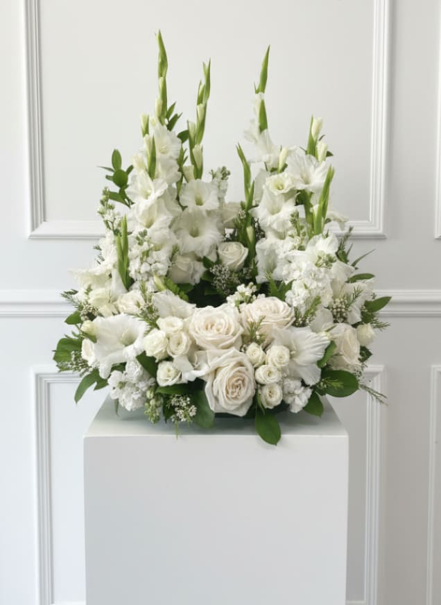 White Urn Garden - Large all-white urn with layered roses, ruffled blooms and tall spikes, densely packed with green accents