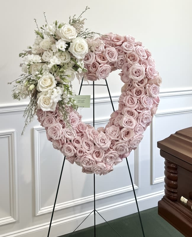 Pink and White Heart Easel - Large heart wreath of tightly packed pink roses with white rose cluster and filler, on easel stand