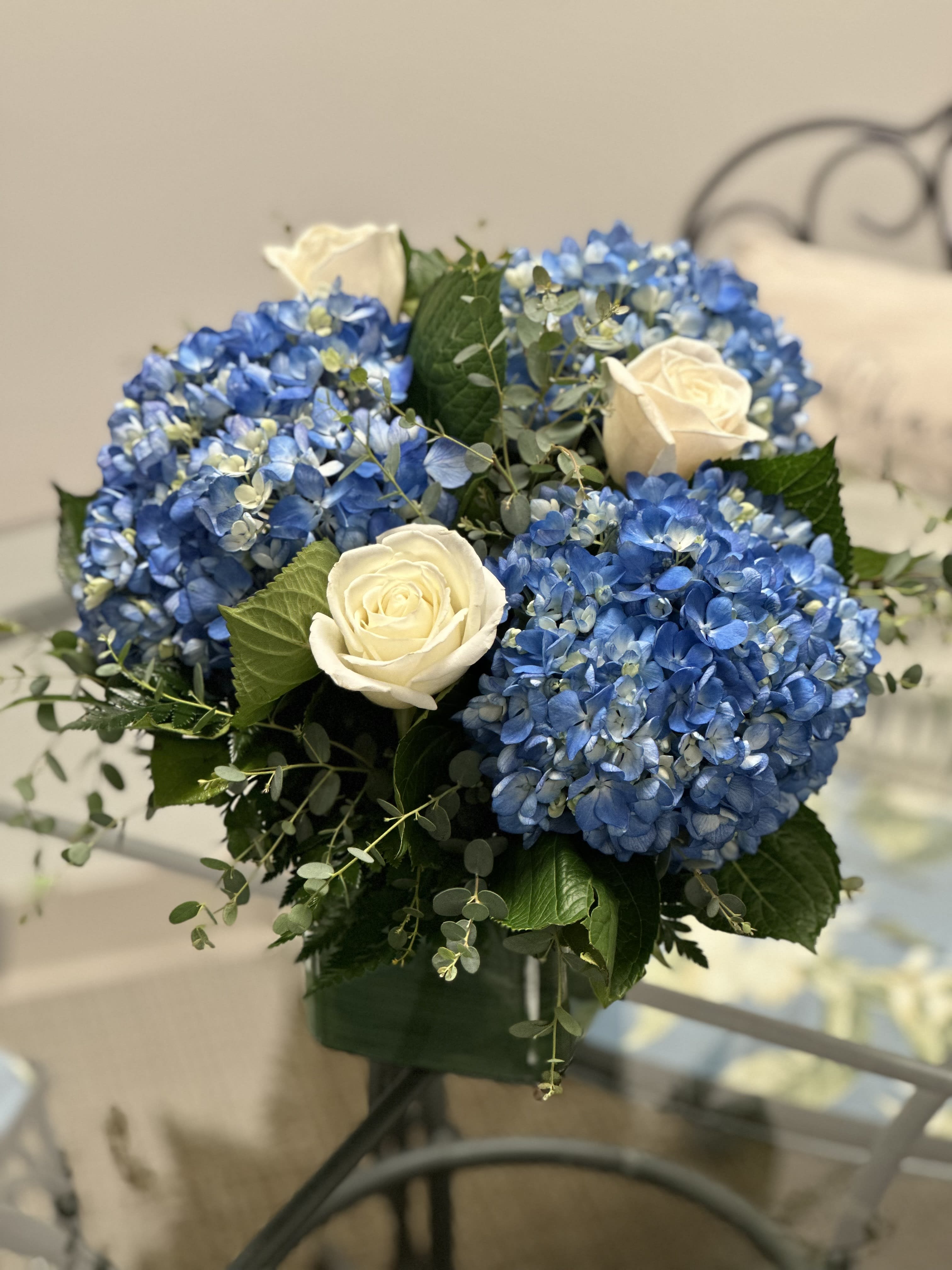 Blue hydrangea bouquet with white roses in a vase