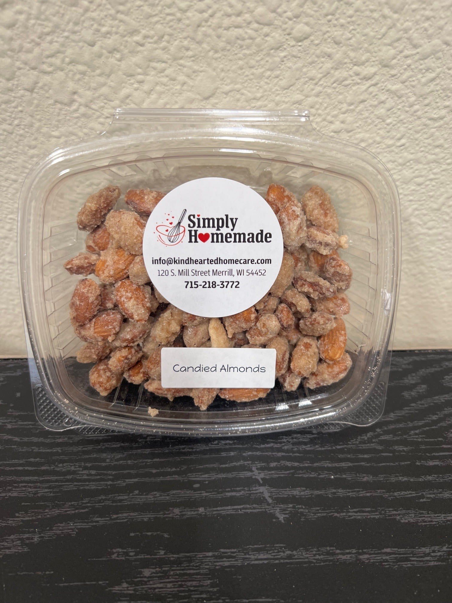 Container of candied almonds with a branded label