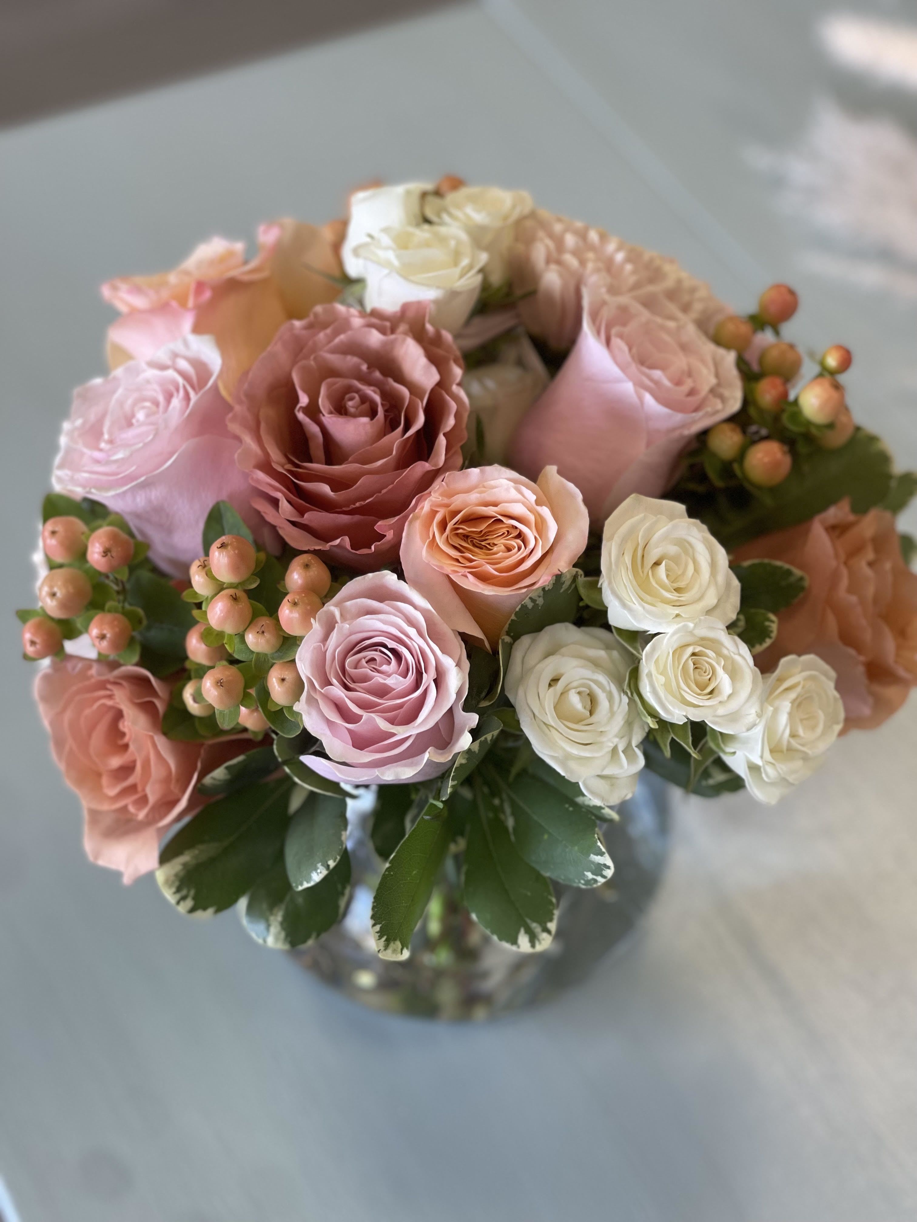 Bouquet of pink and white roses in a glass vase