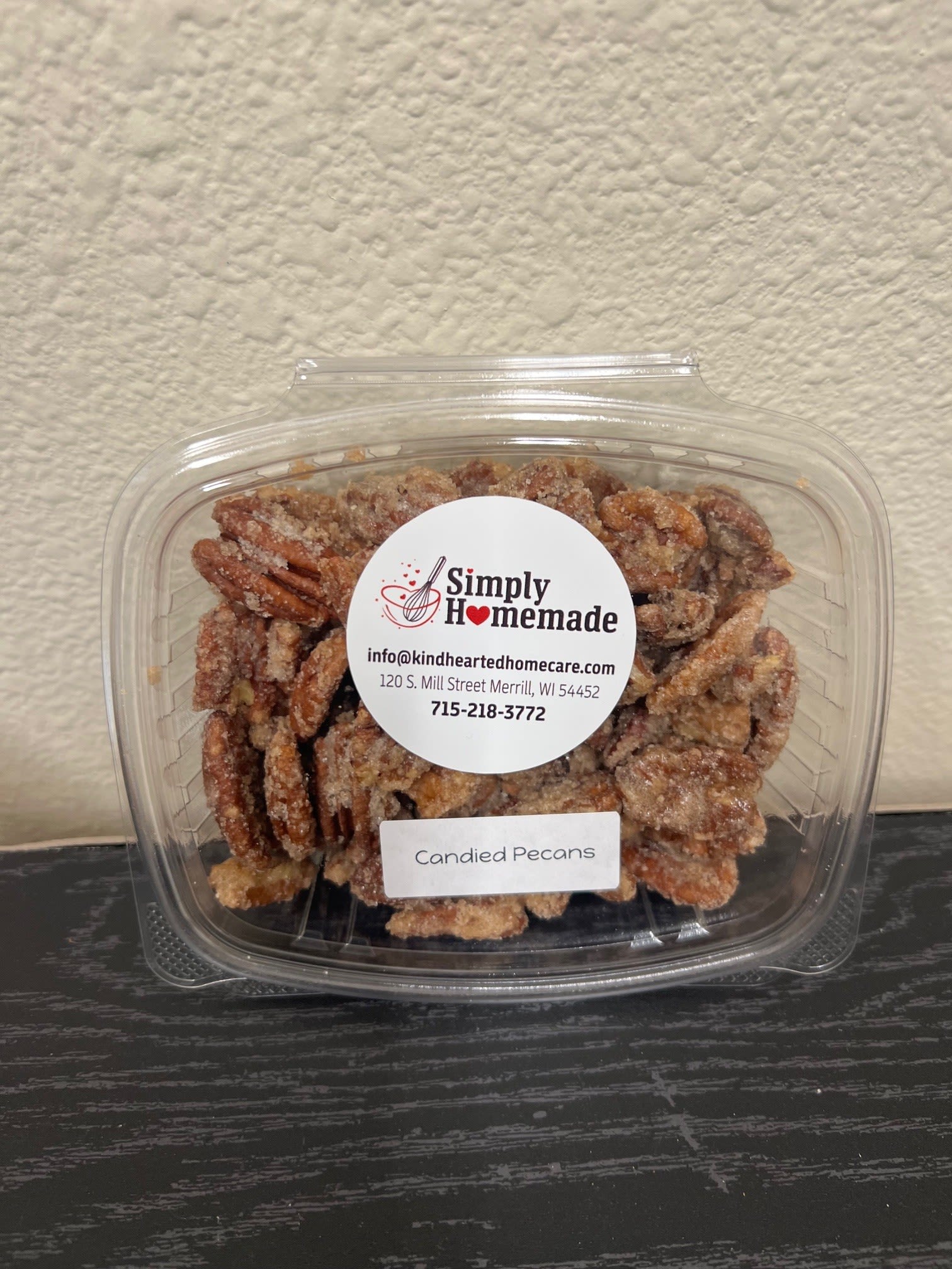 Container of candied pecans with a label