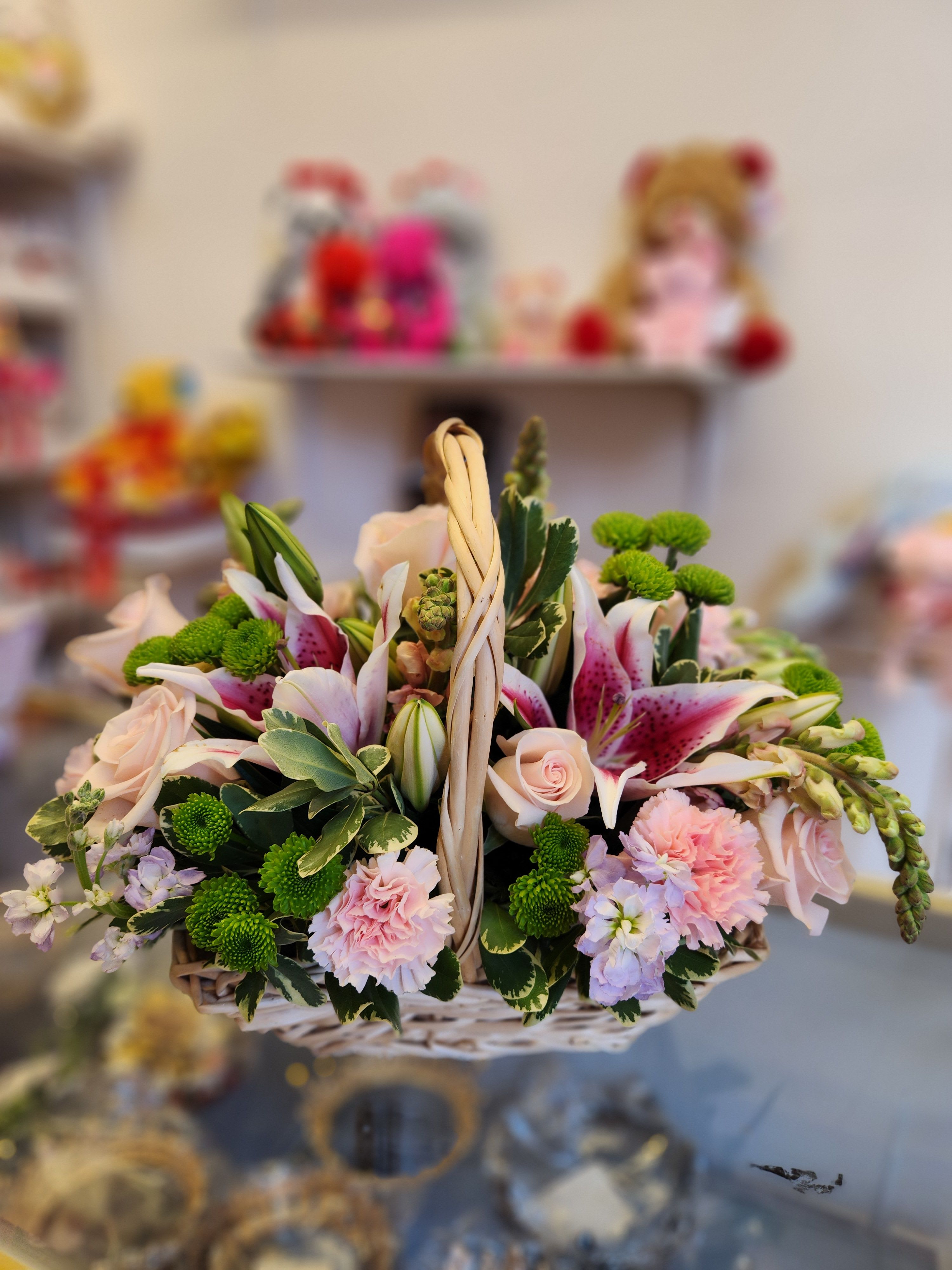 Basket of pink and white flowers with green button mums