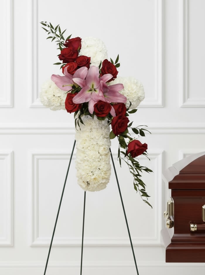 Pink and Red Cross - Tall standing spray with white base, clustered red roses, pink lilies and metal easel for display