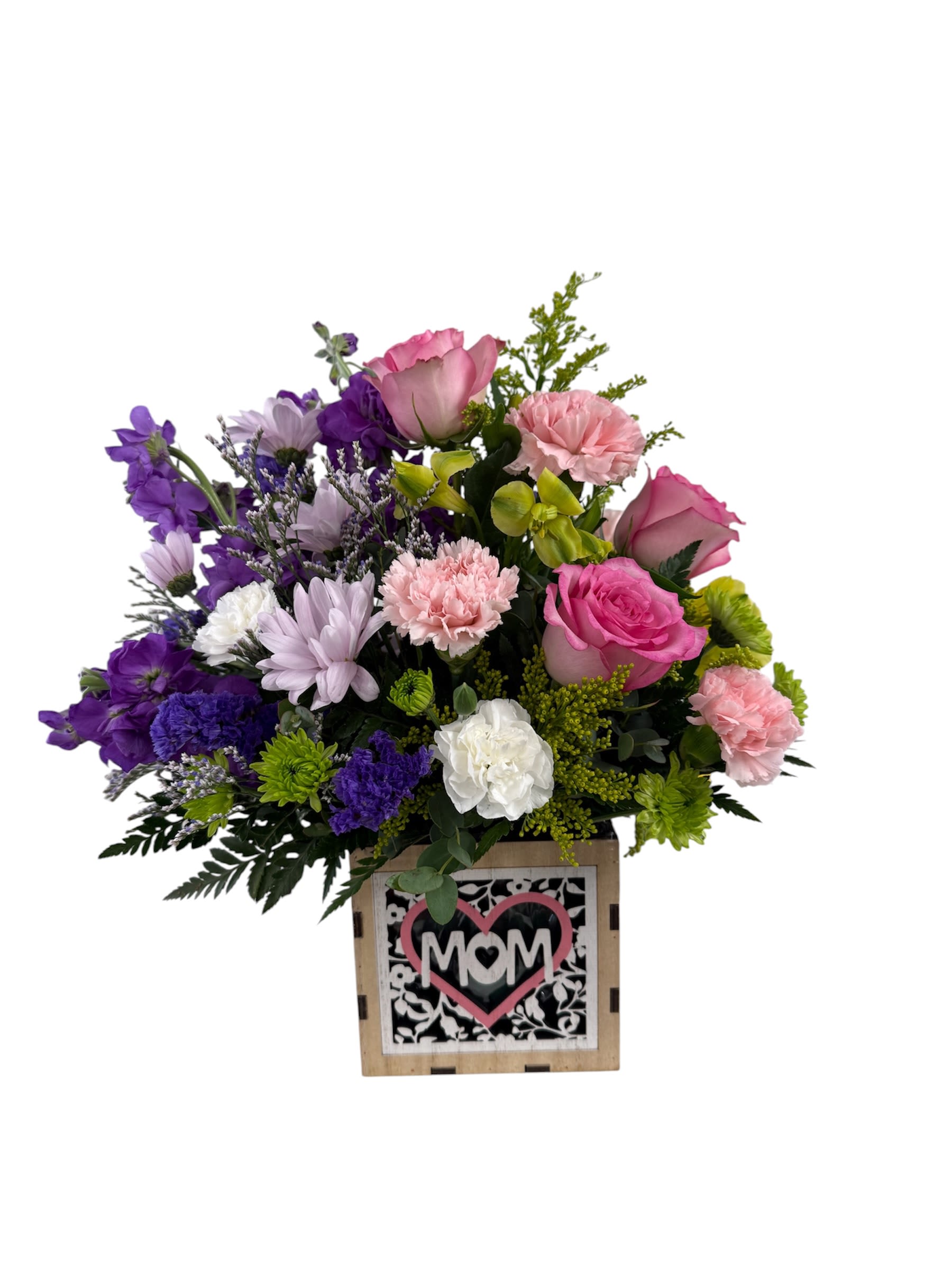 Mom's Meadow - Soft pink roses and ruffled carnations mingle with pale lavender and white daisy-like chrysanthemums and lively purple accents to create a warm, affectionate Mother's Day or thank-you flower arrangement. Designed as a "Mom's Meadow" gift, this flower arrangement in a rustic wooden box reads like a handcrafted tribute-cheerful yet tender-so the person you're celebrating will feel genuinely seen and appreciated.   