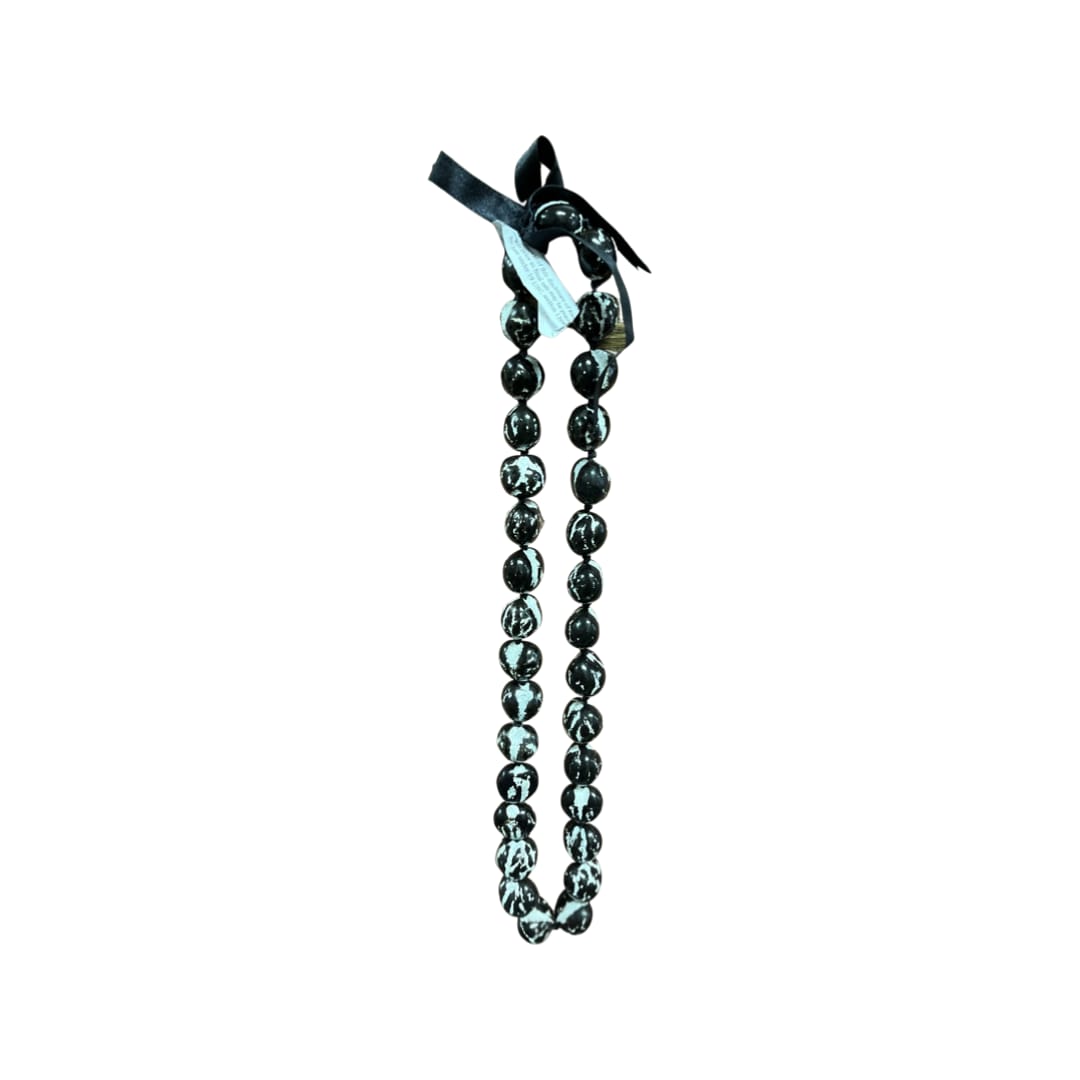A long strand of dark beads tied with a ribbon