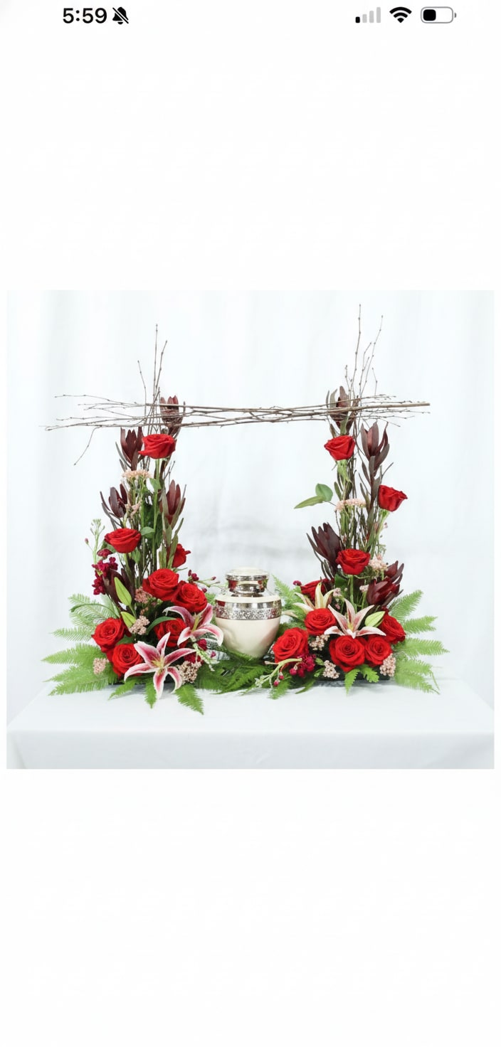 Red Modern Urn Garden - Classic urn arrangement with abundant red roses, white-pink lilies, dark burgundy foliage, and decorative twig frame.