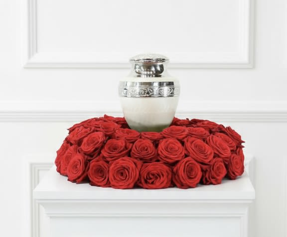 Rose Urn Garden - Dense ring of vivid red roses arranged around an urn for a classic, romantic display