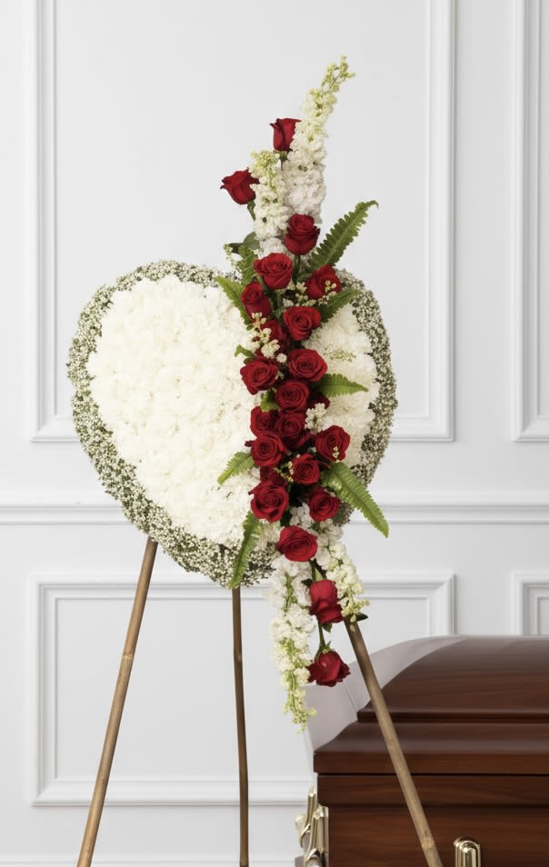 Red and White Closed Heart - Tall standing spray with a vertical line of red roses through a rounded white mass, on an easel.