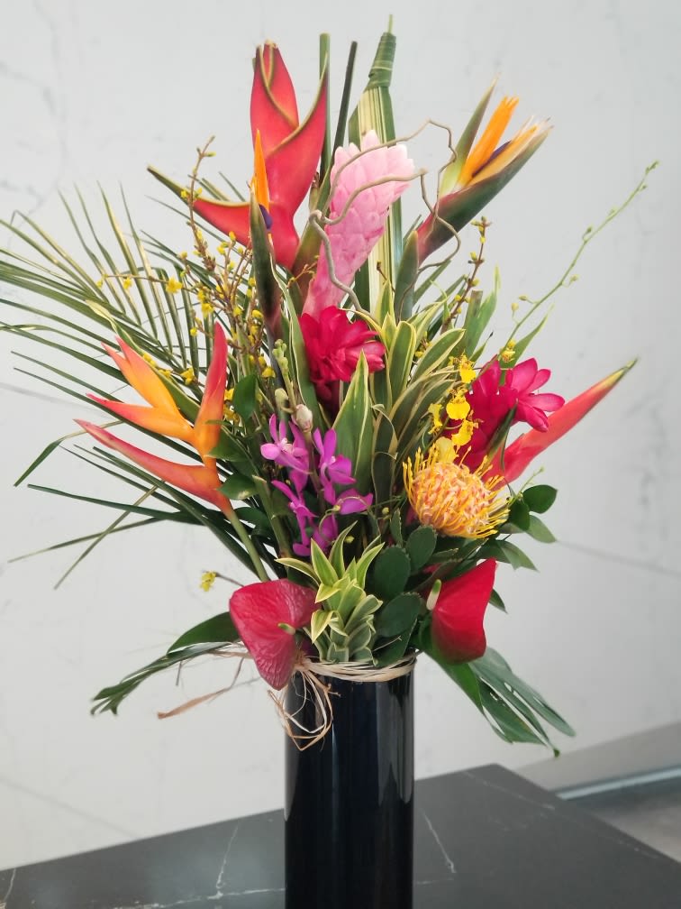 Tropical Bliss (TWO DAY ADVANCE ORDER)  - A beautiful tropical arrangement in a black glass cylinder. Approx: 30" tall.  Transport to Hawaii and escape for a moment of relaxation.... 