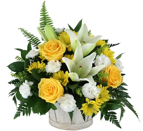 Yellow roses and white lilies arranged in a white container