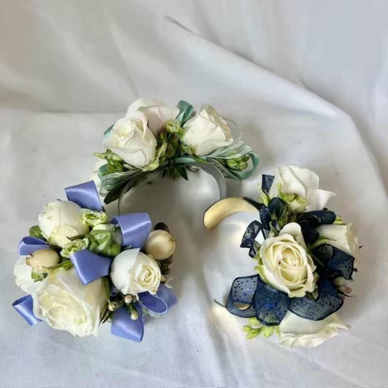 Corsages - Please state what color flowers, what color ribbon and if you'd prefer us to use a silver or gold cuff. We will use your request to the best of our ability, if you are looking for something specific, please call us at 919-493-1593 and we can help you from there.