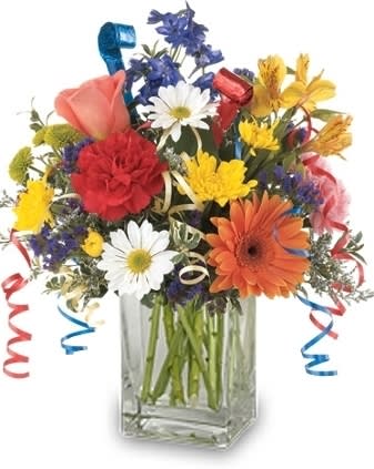 Colorful mixed bouquet in a clear glass vase with ribbon curls