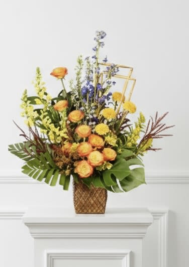 Masculine Vase Arrangement - Clustered orange roses, yellow mums and purple spikes in a woven vase with tropical greenery.