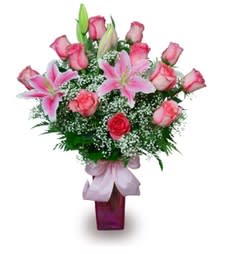Pink roses and lilies arranged in a purple vase