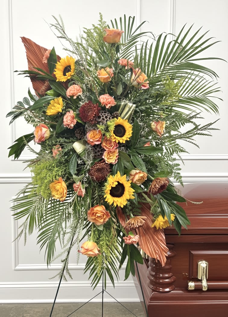 Fall Standing Easel - Large standing spray with sunflowers, peach-orange roses, coral carnations on a floral easel.