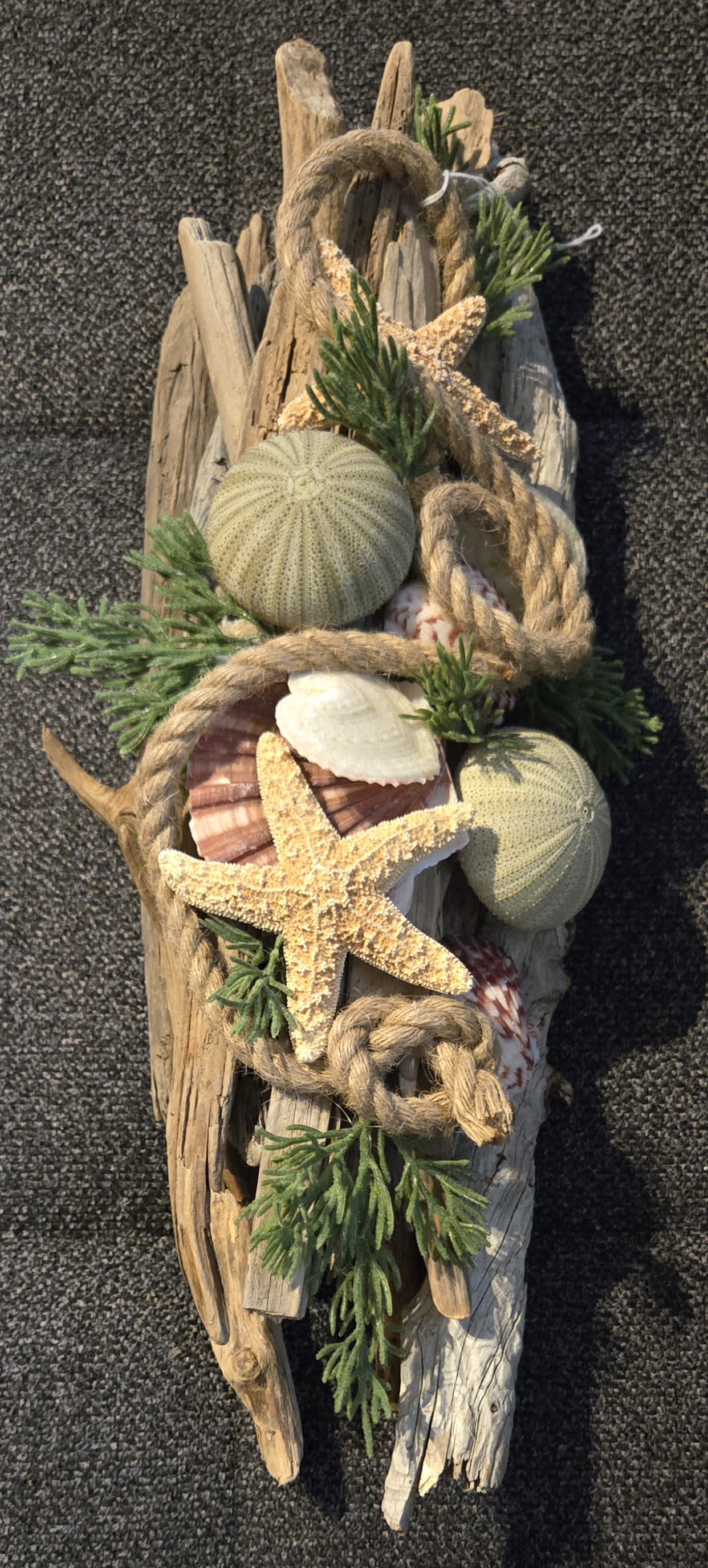 Drifting Coastal Breeze - This one-of-a-kind custom driftwood base design style is stunning! Ideal for an buffet, mantel, entryway or centerpiece scape. No water needed...lol  Beautifully appointed seashore collection of shells, faux botanicals, roping and natural driftwood. Approximately 12-14"
