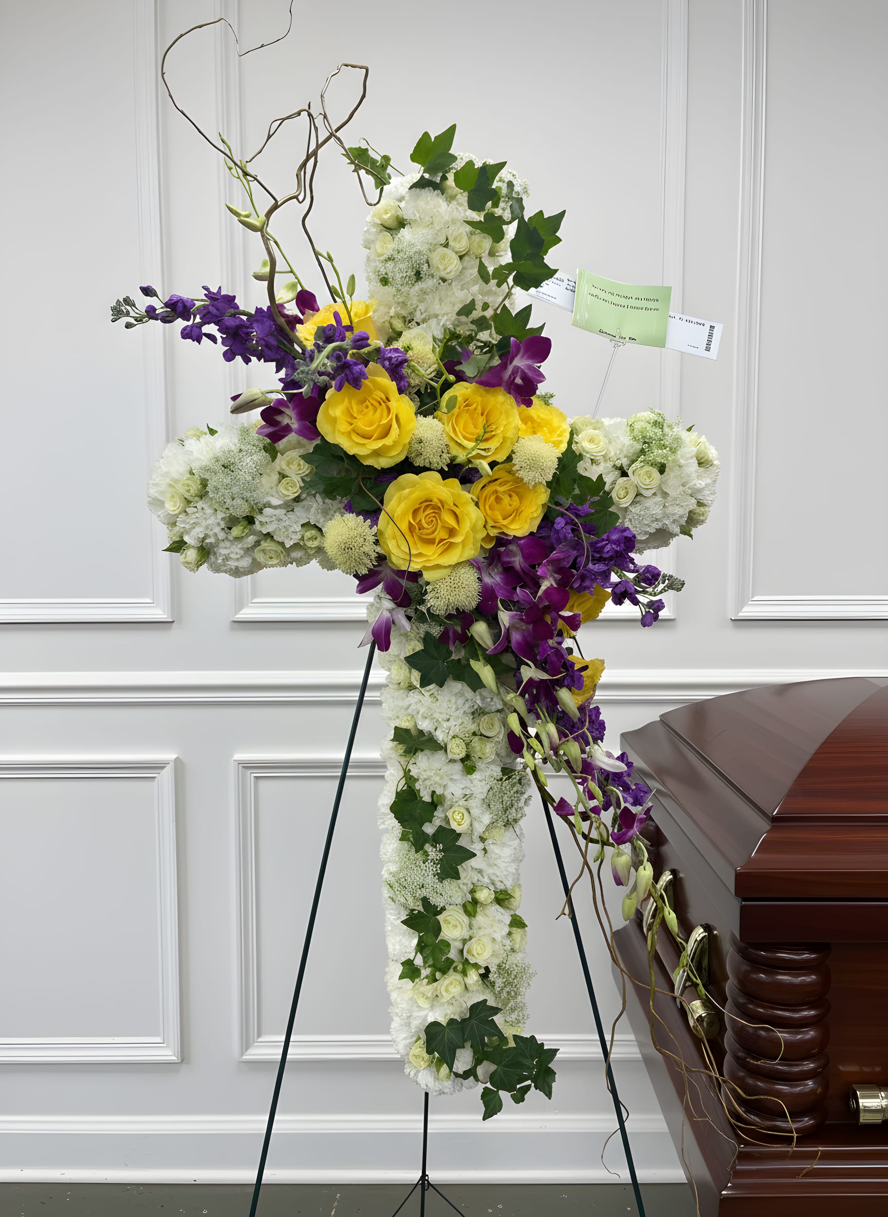 White and Yellow Cross - Large standing cross on an easel with white base, bright yellow roses and cascading purple orchids, card holder included