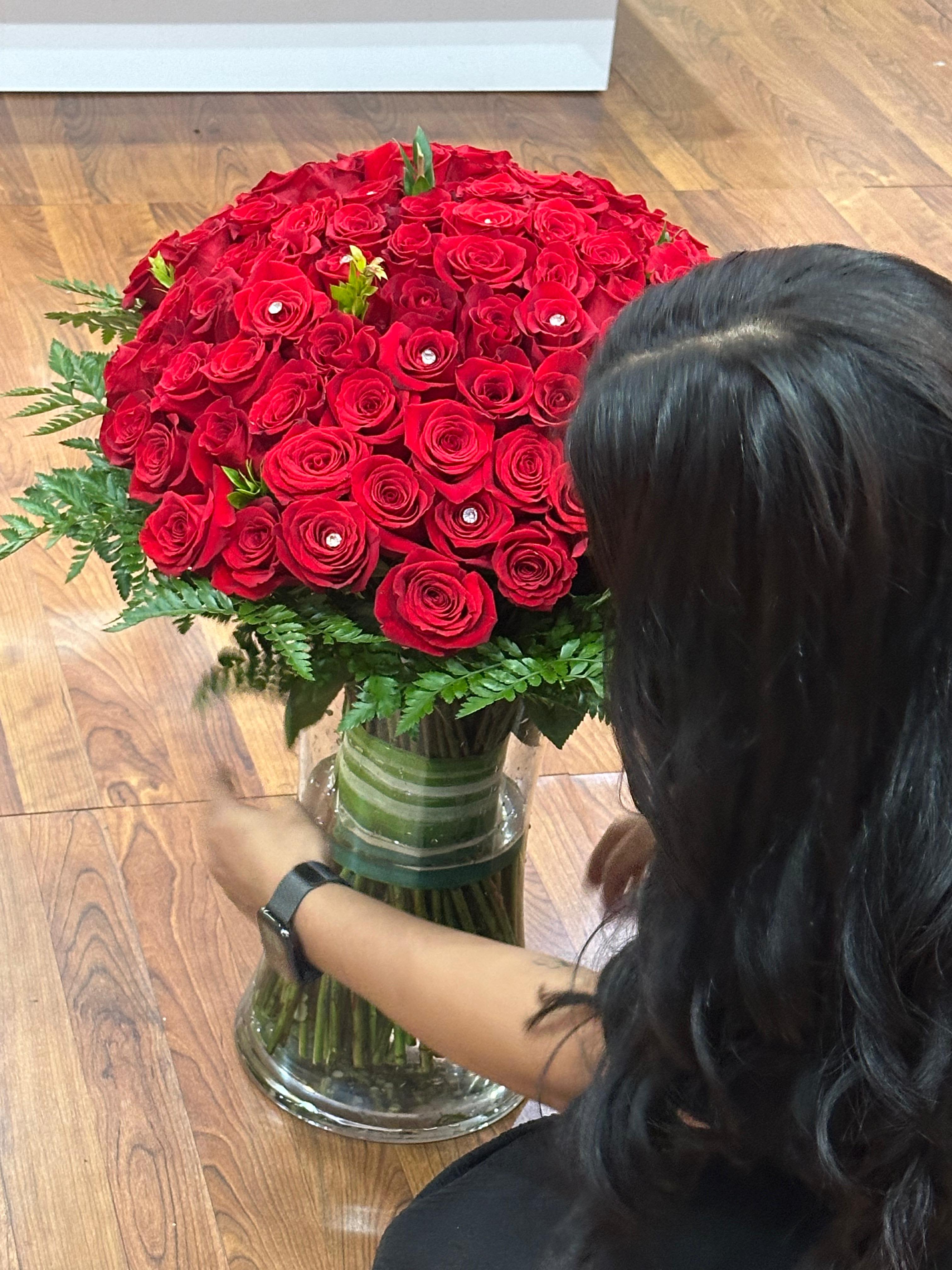 Large bouquet of red roses in a glass vase