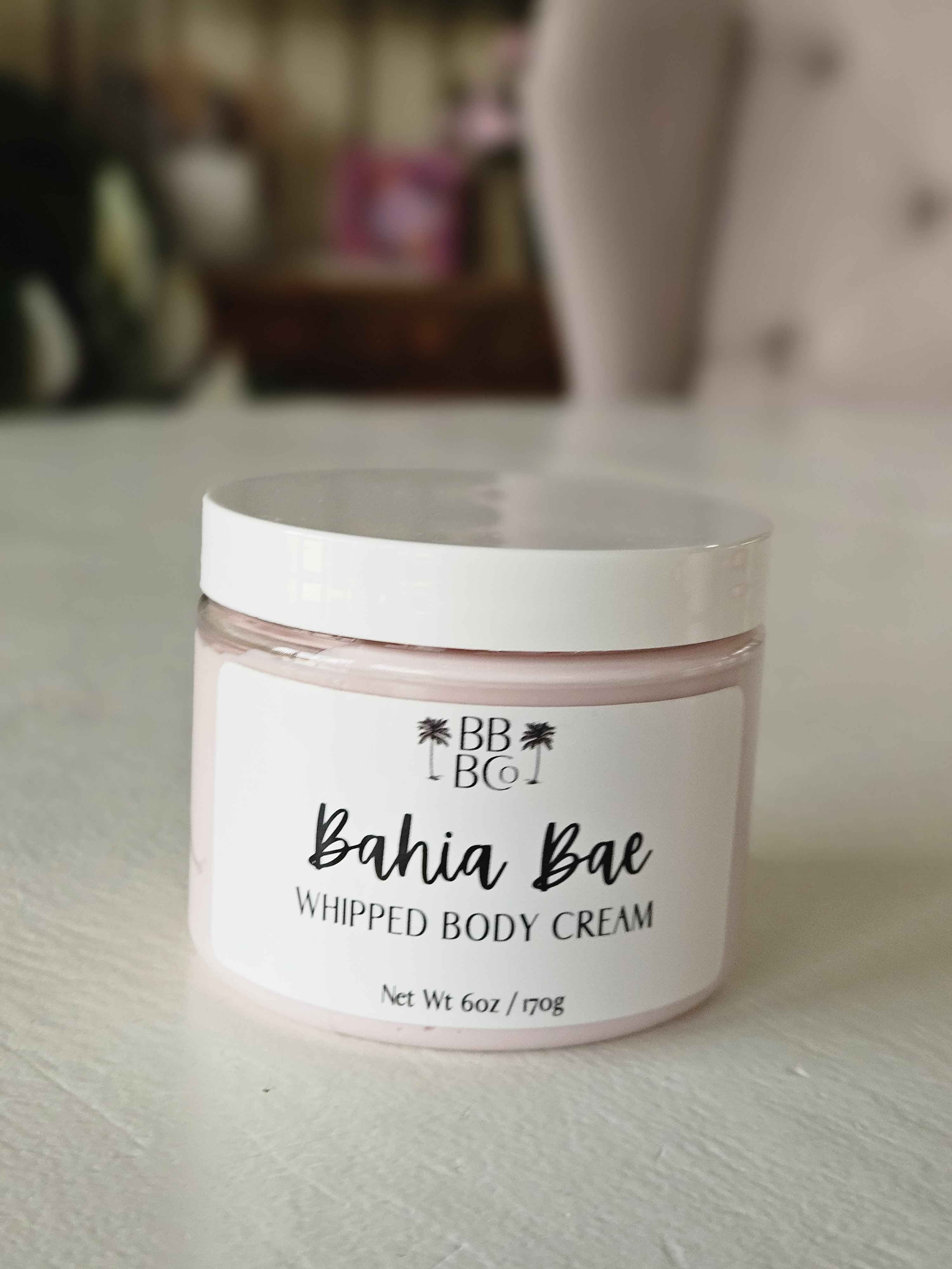 Bahia Bae Whipped Body Cream - Escape to Bahia, (Bae!) with our Bahia Bae whipped body cream! We're bringing this Tampa beach to you with a sweet, beachy blend that captures the essence of a sun-soaked getaway. Infused with exotic notes of fresh flowers, luscious coconut, soothing musk, and warm sandalwood, this body cream delivers paradise in your daily self care. Indulge in the ultimate tropical escape and embrace the glow of Bahia Bae Whipped Body Cream—your perfect companion for radiant, hydrated skin.