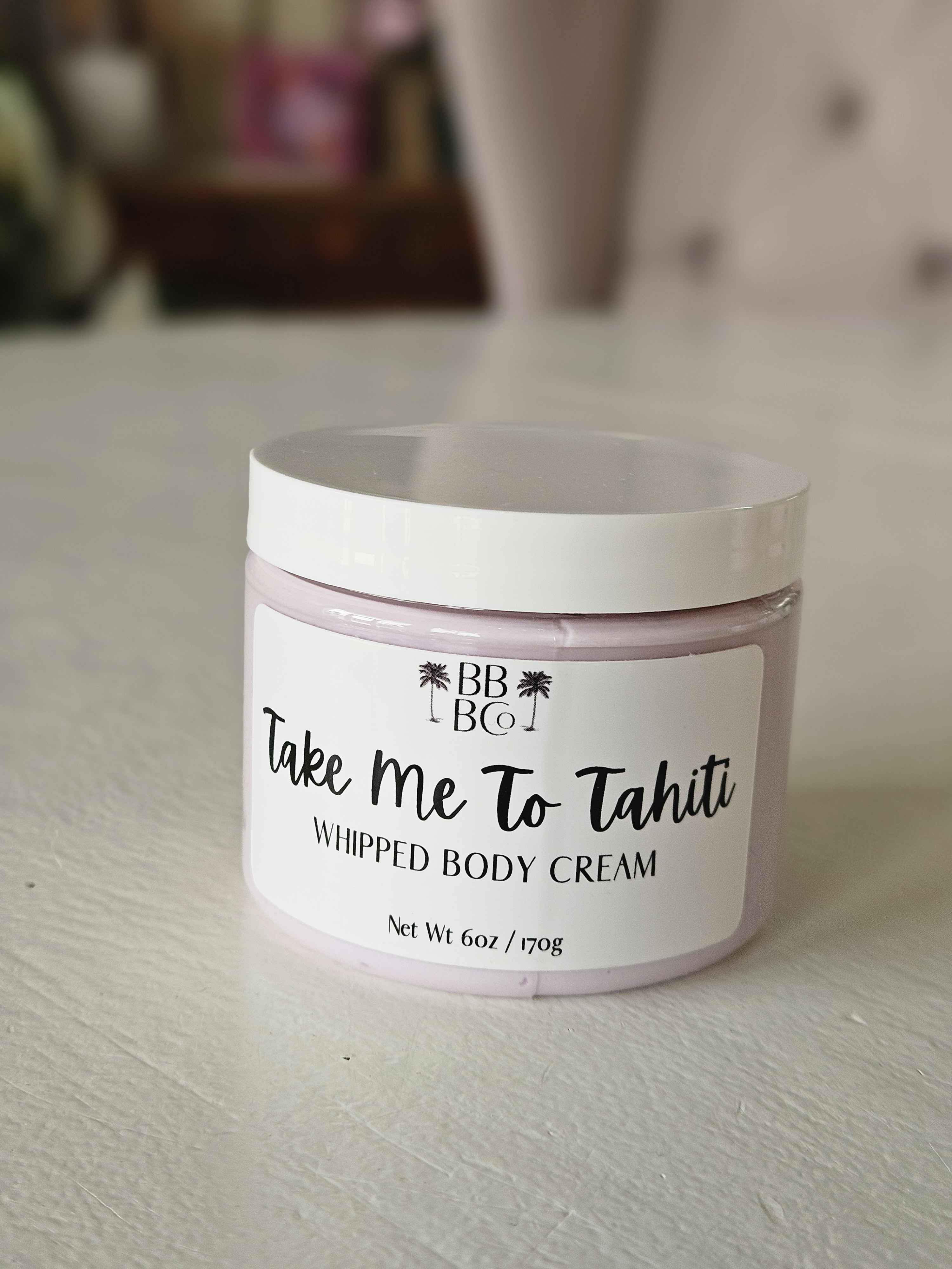 Take Me To Tahiti Whipped Body Cream - Take Me To Tahiti whipped body cream... yes, please! This best-selling cream is like a tropical vacation in a jar. With lush notes of coconut water, kiwi blossom, bergamot, vanilla, and white musk, it’ll whisk you straight to paradise. Smooth it on and let the dreamy scent transport you to sandy beaches and warm breezes. It’s the ultimate treat for your skin—and trust us, you’re going to love it!