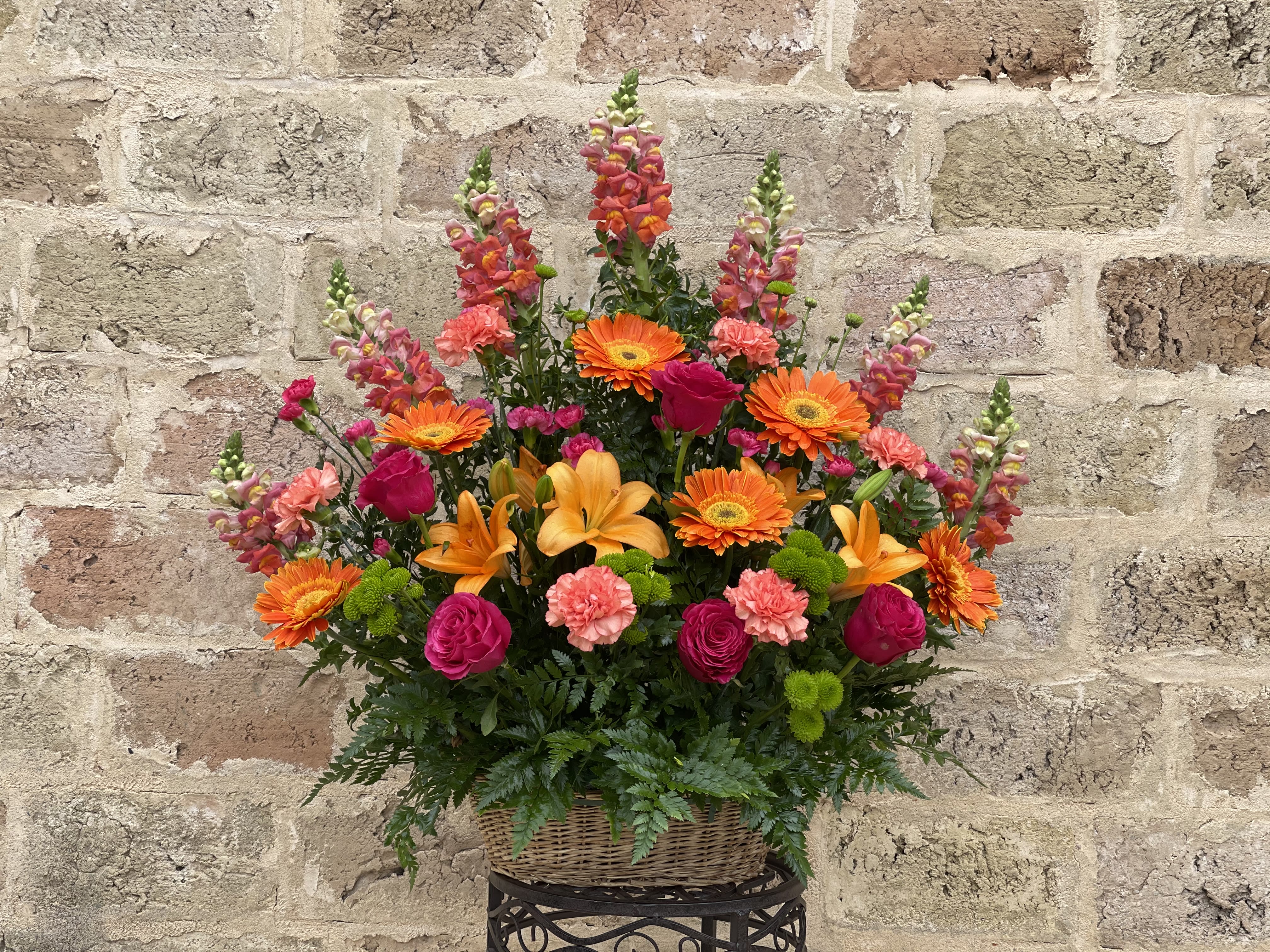 Colorful mixed flower arrangement in a wicker basket