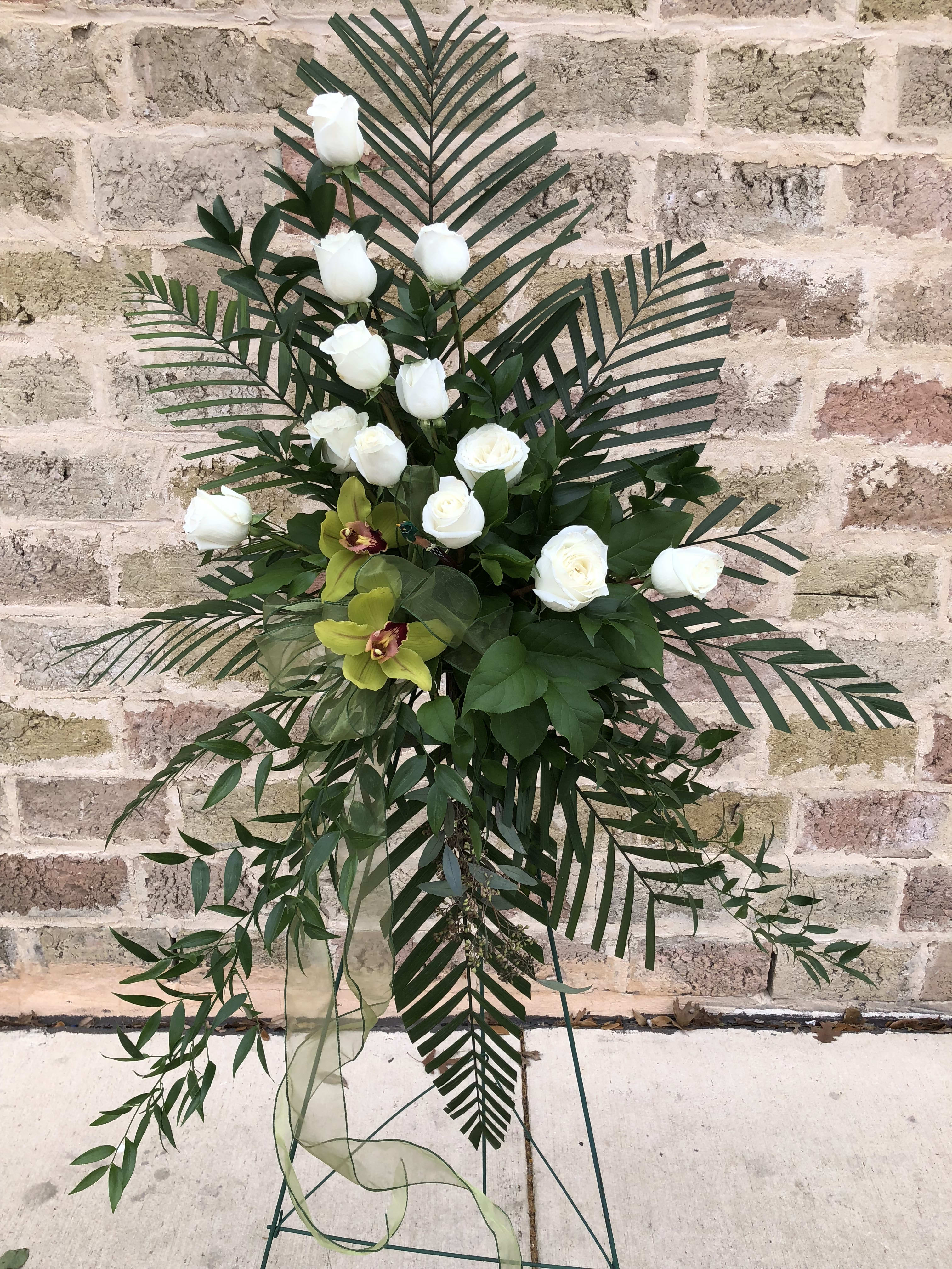 Tall floral standing spray with white roses and tropical greenery