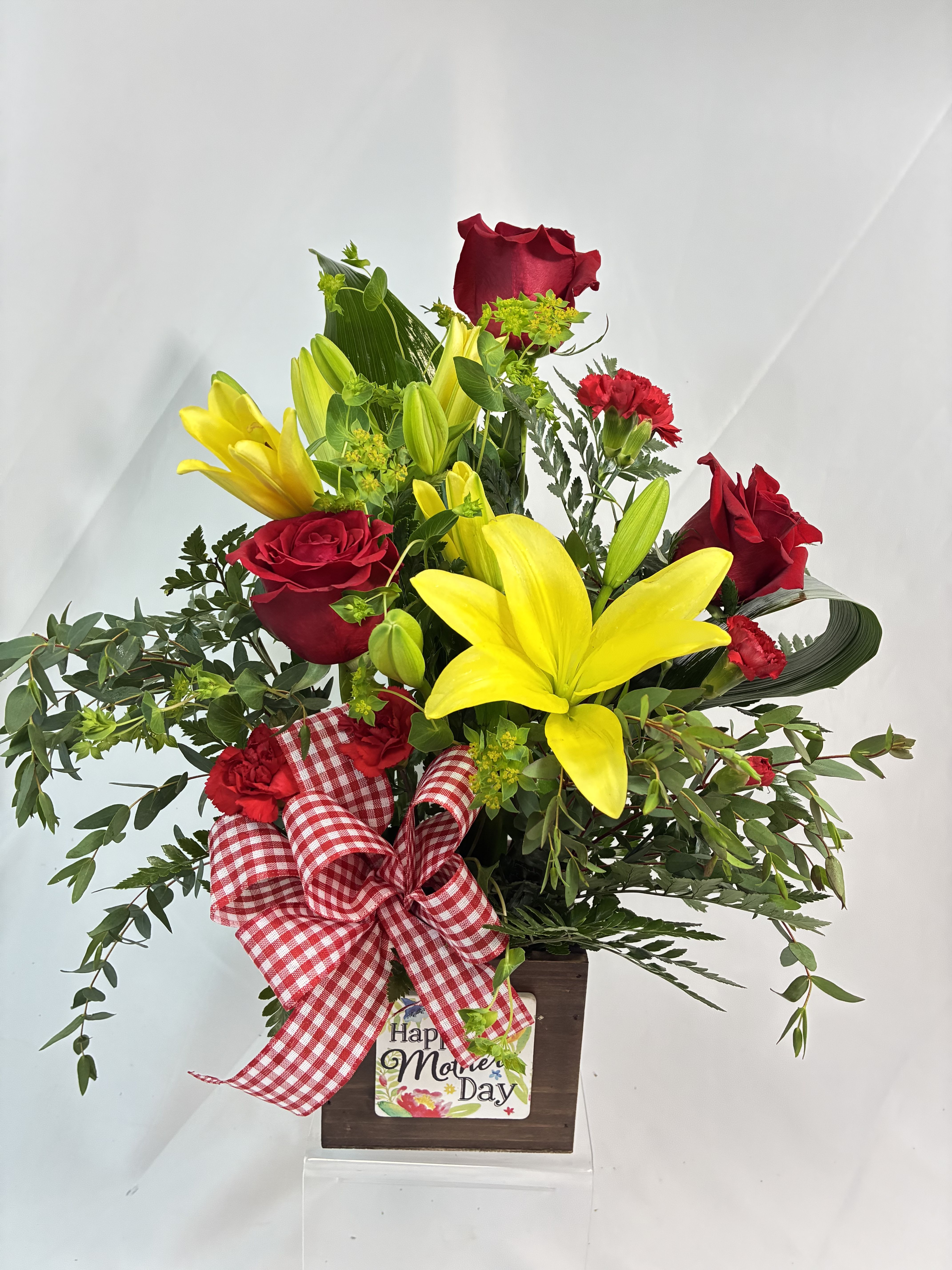 Thanks Mom Bouquet - Thank Mom for Mother’s Day with this bright, fresh bouquet in this keepsake wood box planter. Featuring upgraded red Roses, yellow Lilies, Chrysanthemums with stylistic accents of Aspidistra leaves and Eucalyptus. 
