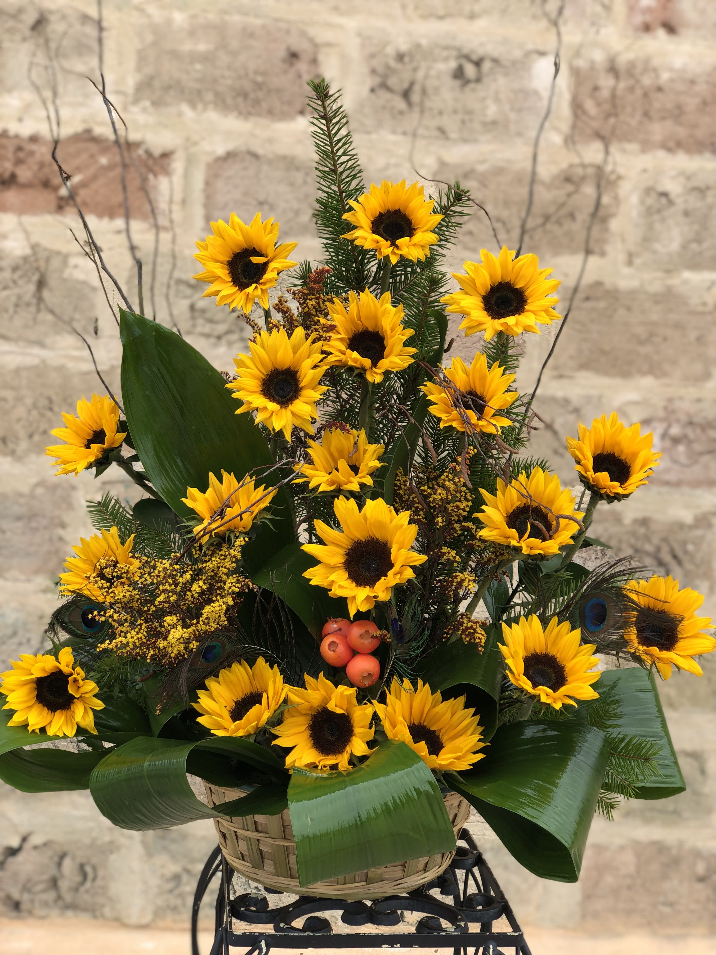 Basket arrangement of yellow sunflowers with dark centers