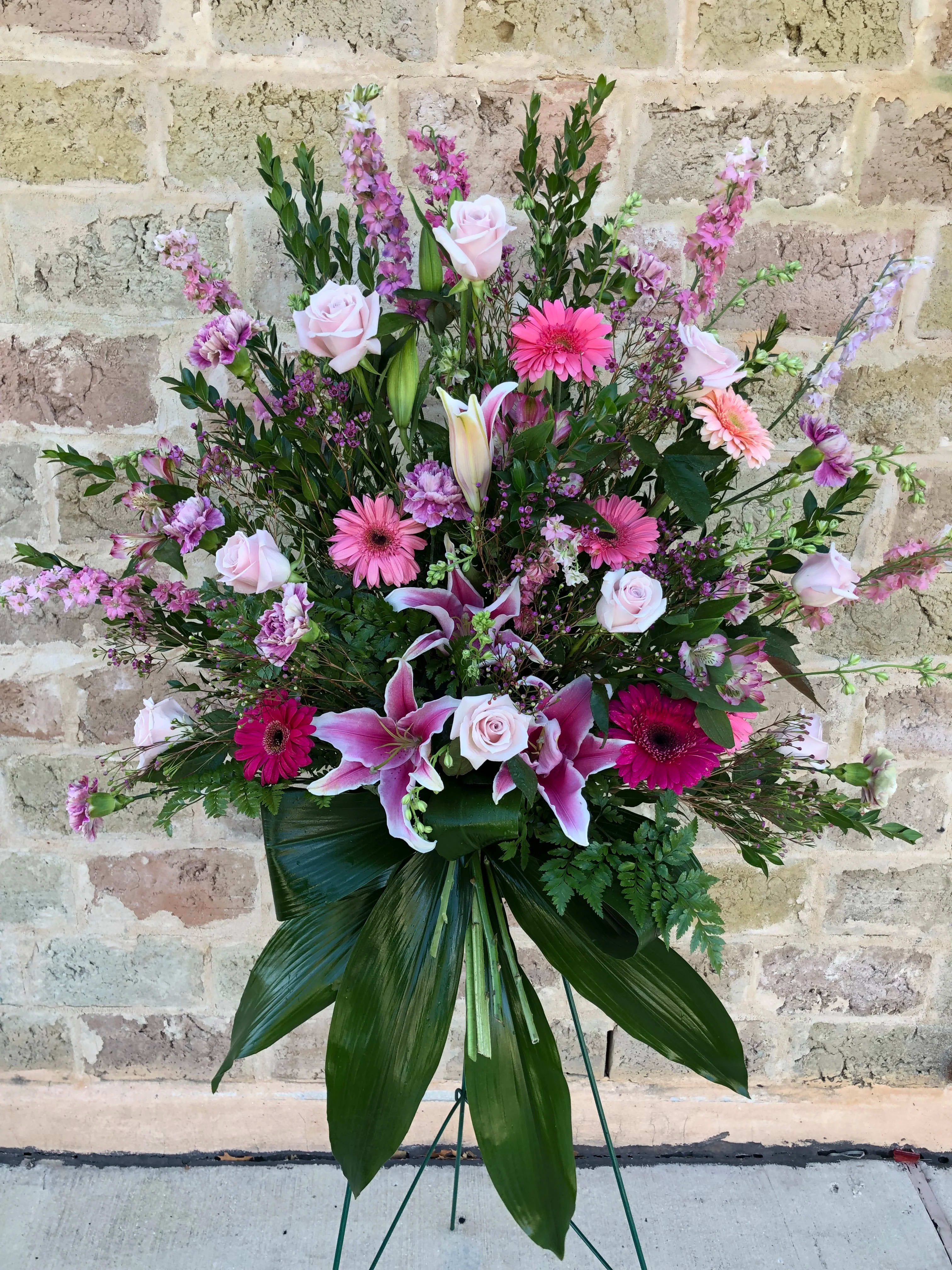 Large pink and white floral standing spray on an easel