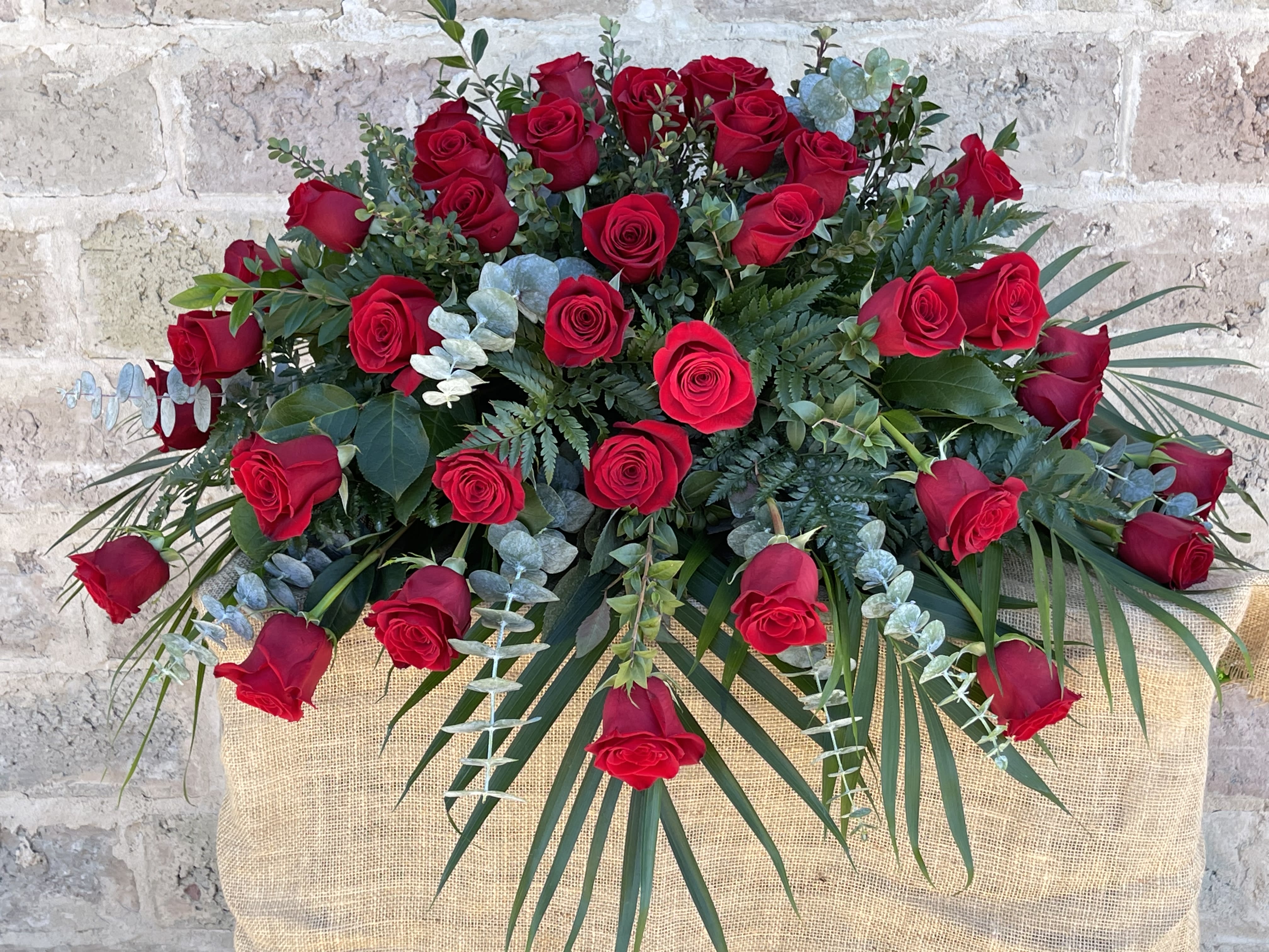 Large bouquet of red roses with eucalyptus and palm fronds