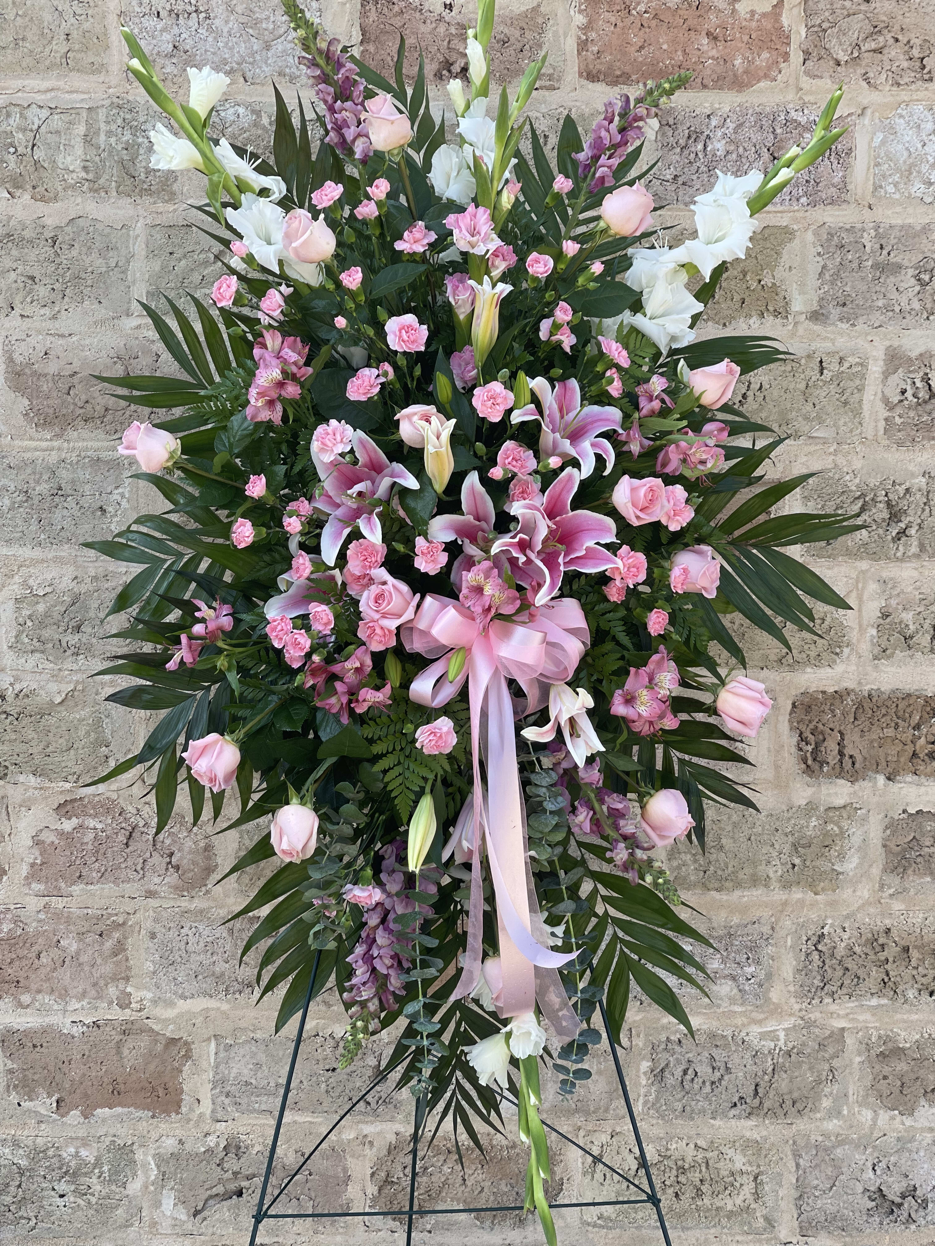 Tall pink and white floral standing spray with lilies and roses