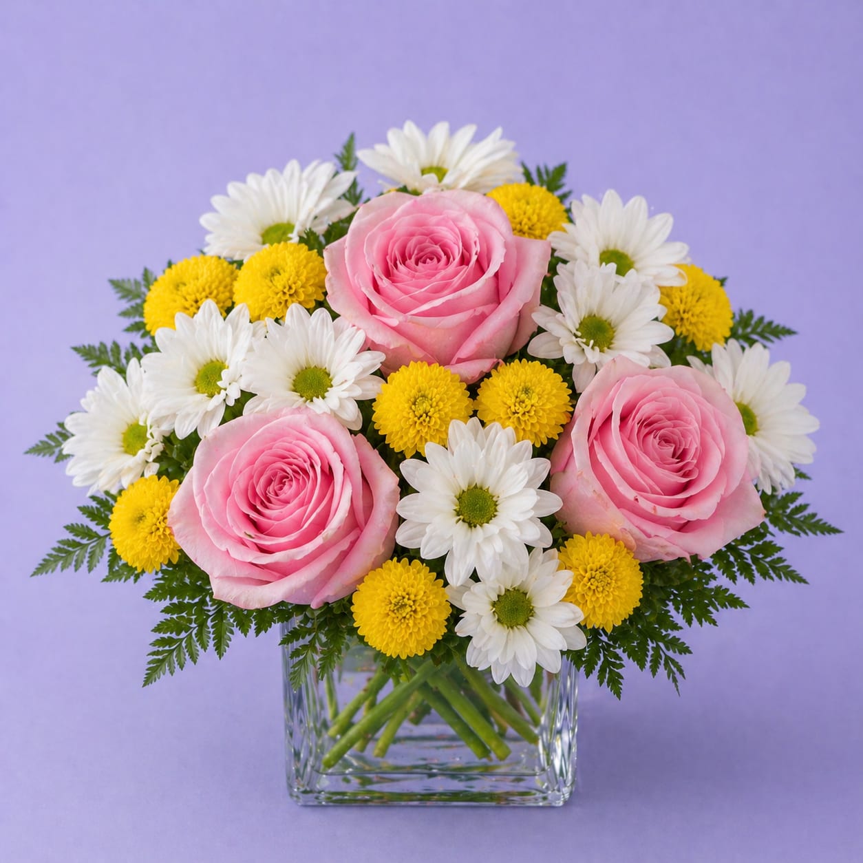 Sweet Blush Daisy – Pink Rose &amp; Sunny Mum Arrangement - Bright, cheerful, and full of charm — our Sweet Blush Daisy arrangement is a perfect everyday favorite. Featuring soft light pink roses, fresh white daisy mums, and vibrant yellow button pom mums, this design delivers a beautiful balance of color, texture, and freshness.  Arranged in a clear glass cube vase, this bouquet offers a clean, modern look that fits any space. It’s ideal for birthdays, get well wishes, thank you gifts, sympathy, or just because flower delivery.