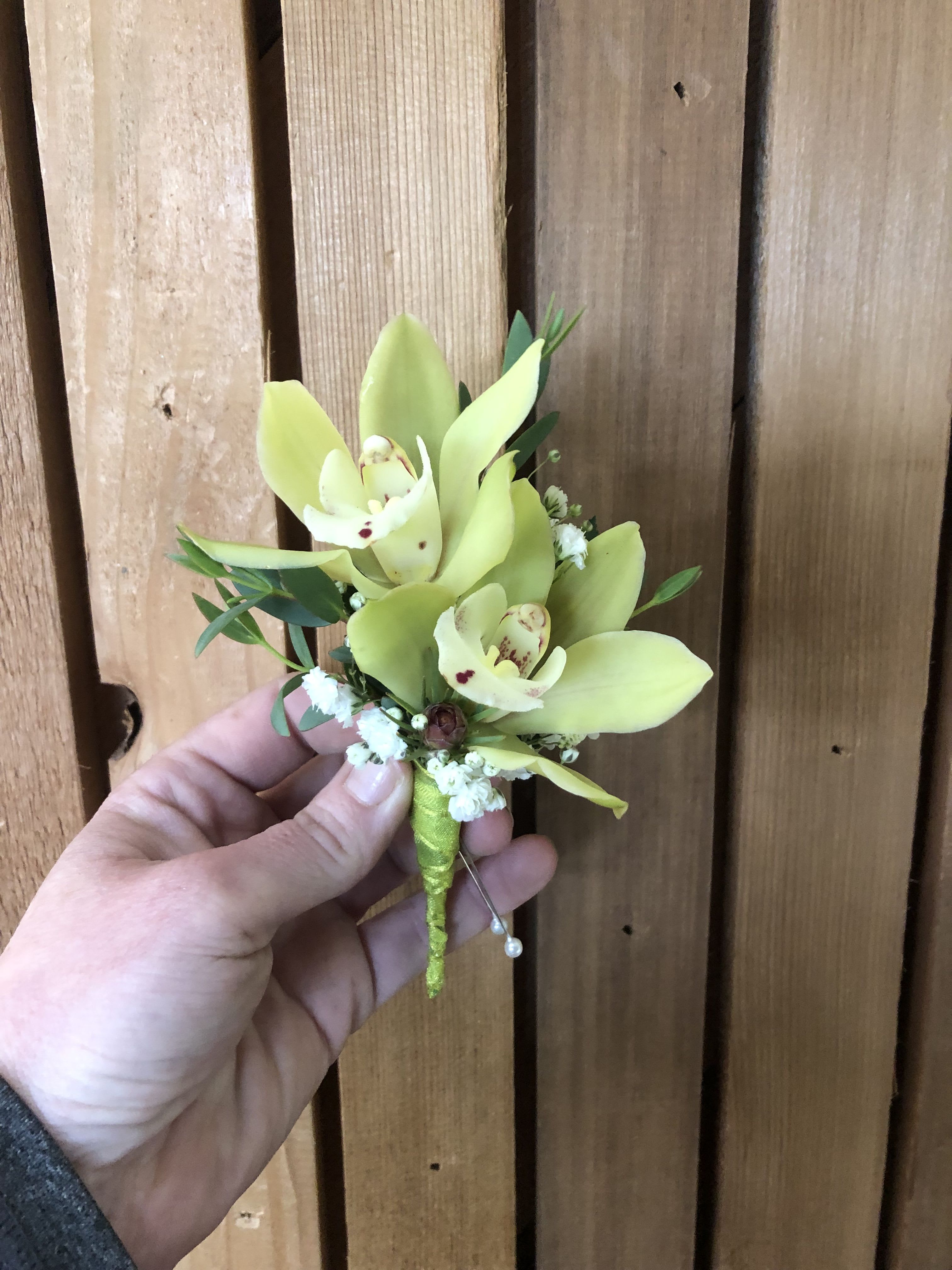 Custom Boutonniere - Our boutonnieres are thoughtfully designed to complement your look, with multiple styles available as shown in the photos. For the most personalized result, we recommend calling the shop directly so we can ensure every detail is just right.  If you prefer to place your order online, please include the following information at checkout: the color of the suit or tie and any accent colors you would like incorporated into the floral design. This allows us to create a boutonniere that coordinates seamlessly with your overall style.  Each piece is carefully crafted with attention to detail, balance, and finish to ensure a polished and cohesive look.