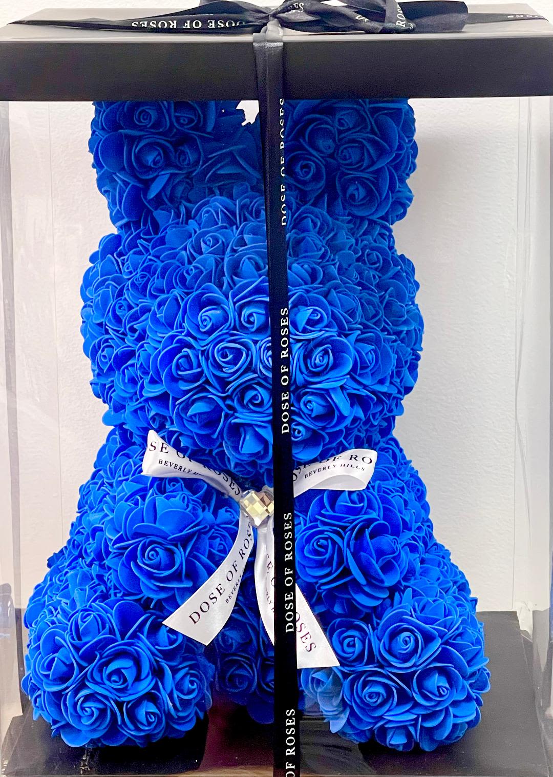 Blue Bunny with Gift box - Blue teddy bear rose bouquet.  colors: Blue  _Crafted with premium red faux roses. _16"/11" Teddy bear adorned with a black ribbon. _Comes in a custom acrylic box for a lasting impression.  Perfect for Valentines Day, Birthday, Mother's Day &amp; Anniversaries 