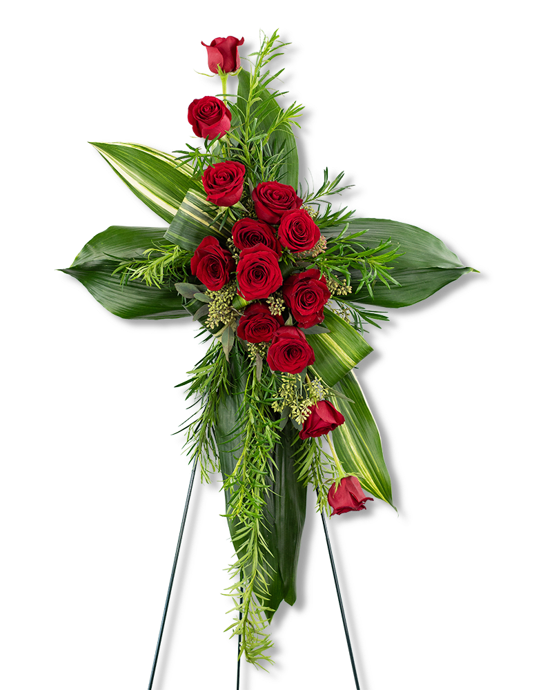 Standing cross with red roses and greenery on a black easel